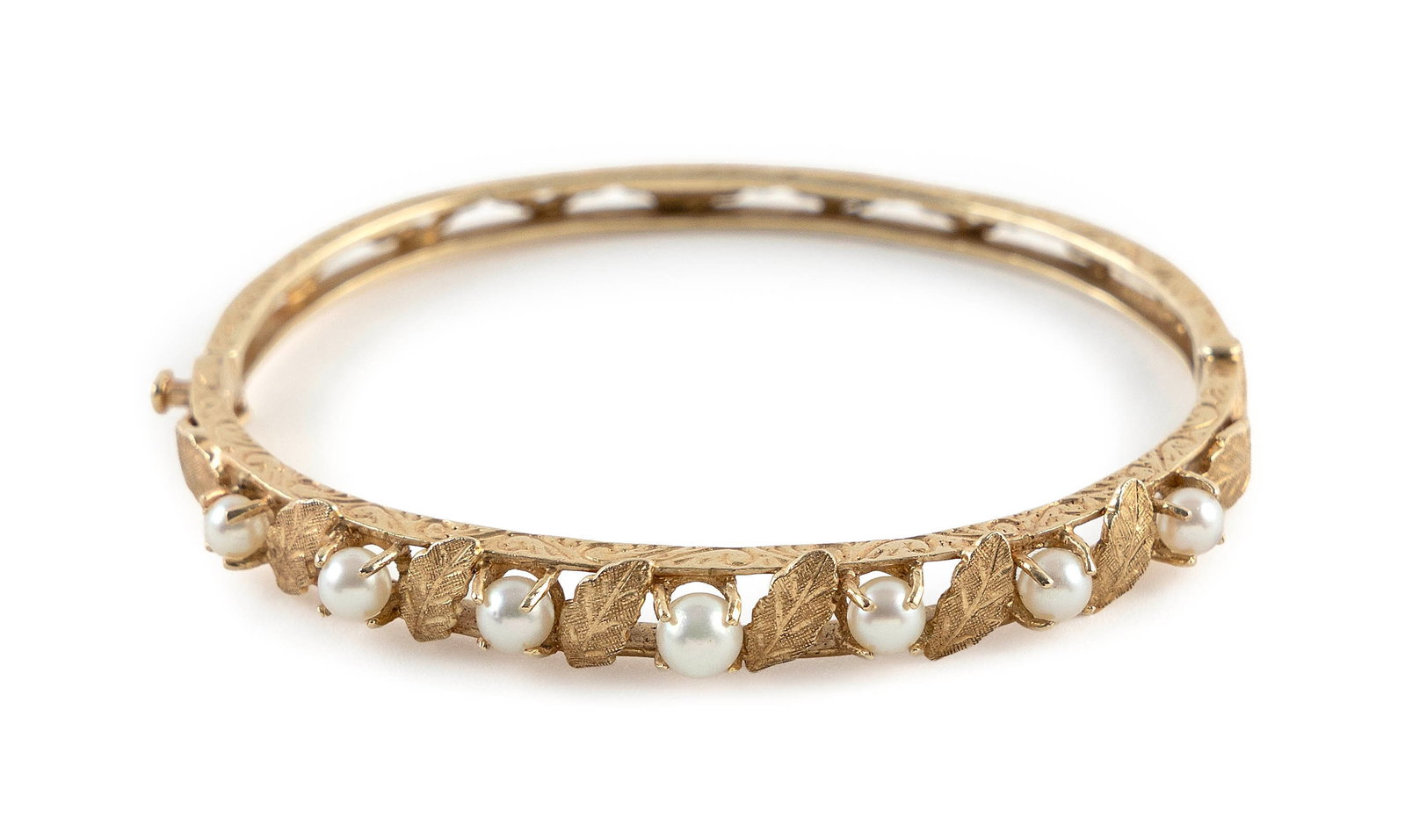 14KT YELLOW GOLD AND CULTURED PEARL BANGLE BRACELET Approx. 8.0 total dwt.: 14KT YELLOW GOLD AND CULTURED PEARL BANGLE BRACELET Floral design with seven approx. 4.0 to 5.0mm pearls. Box clasp with fold-over safety. Stamped. Width approx. 7.0mm. Length 6.5". Approx. 8.0 total 