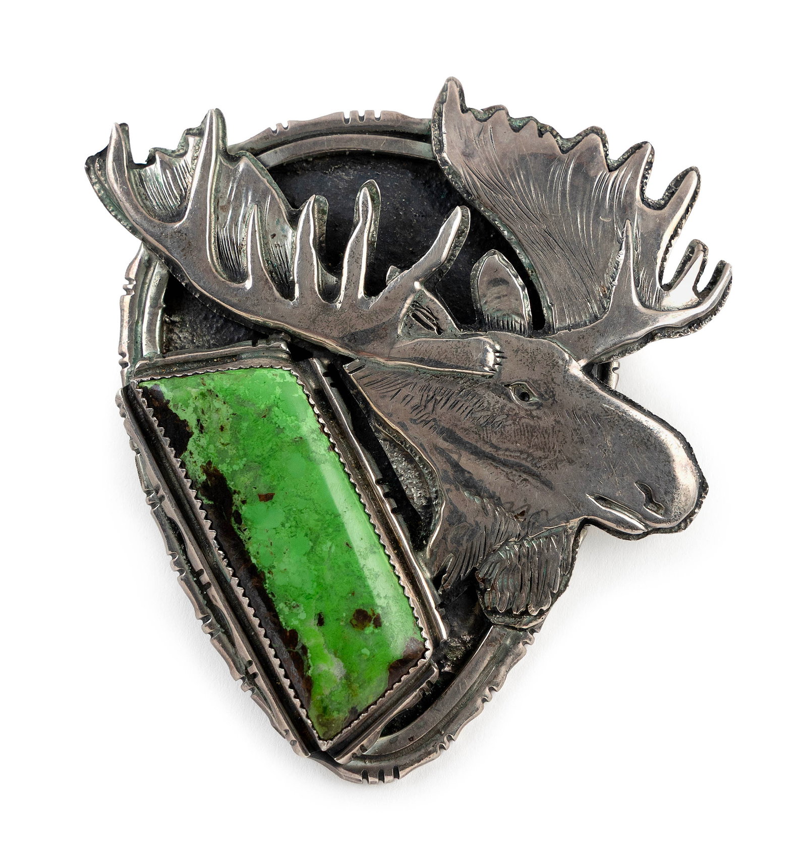 NAVAJO STERLING SILVER AND TURQUOISE BOLO TIE CLASP BY DAN NIELO Late 20th Century Approx. 100.3: NAVAJO STERLING SILVER AND TURQUOISE BOLO TIE CLASP BY DAN NIELO Late 20th Century Large green trapezoidal polished turquoise nugget in a saw-tooth bezel with a profile of a moose. Stamped maker's mar