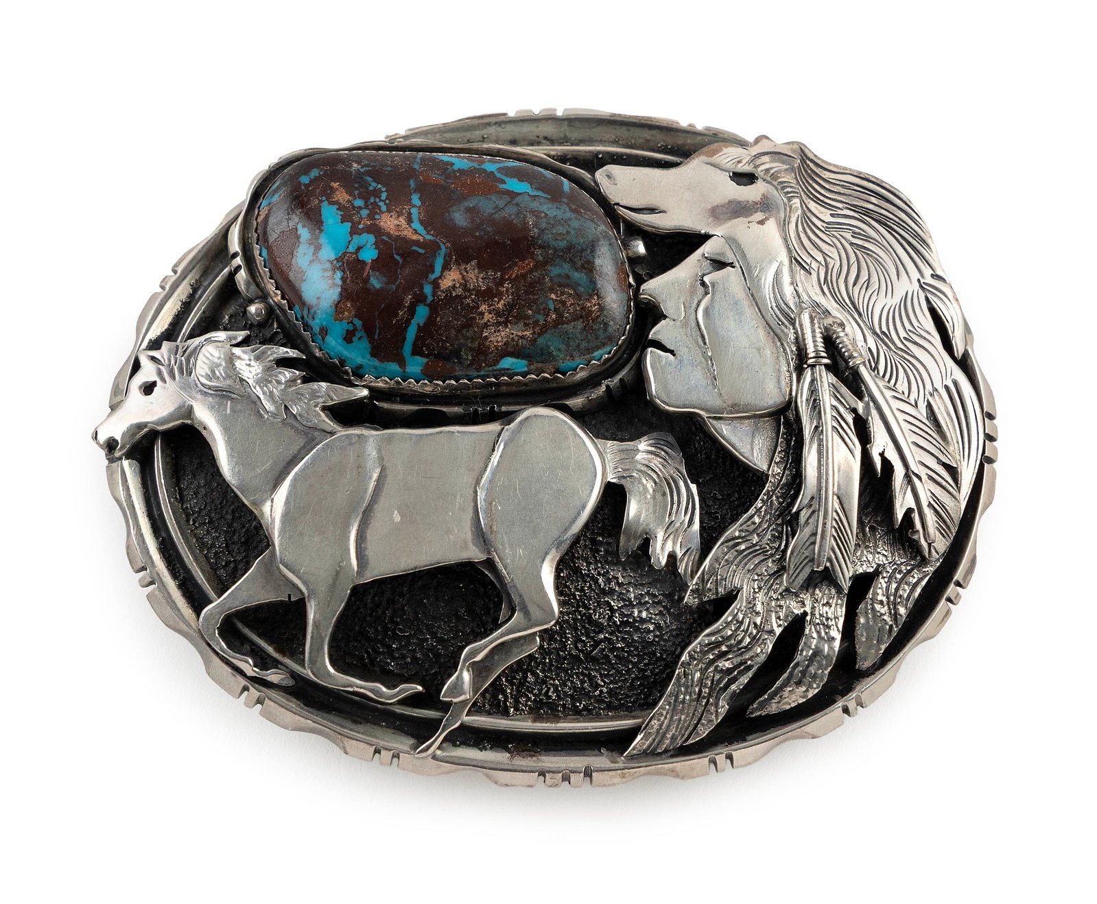 NAVAJO STERLING SILVER AND TURQUOISE BELT BUCKLE BY DAN NIETO Late 20th Century Approx. 104.0 grams: NAVAJO STERLING SILVER AND TURQUOISE BELT BUCKLE BY DAN NIETO Late 20th Century Oval form with profiles of a running horse and a man in a wolf headdress, with polished turquoise nugget in a saw-tooth 