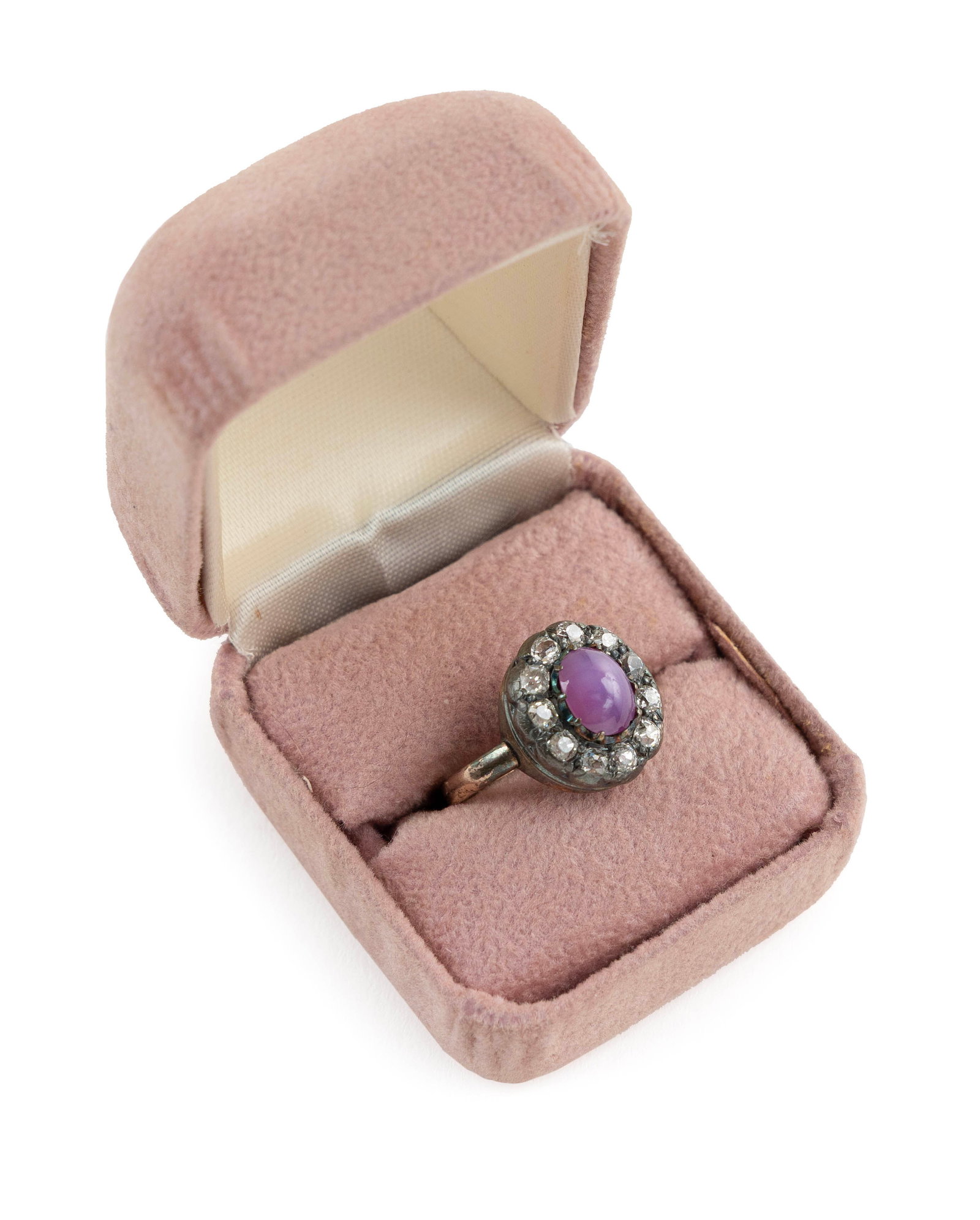 VINTAGE 14KT WHITE AND YELLOW GOLD, PURPLE STAR SAPPHIRE AND DIAMOND RING Approx. 3.4 total dwt.: VINTAGE 14KT WHITE AND YELLOW GOLD, PURPLE STAR SAPPHIRE AND DIAMOND RING One approx. 6.0 x 8.0mm cabochon purple star sapphire with well-defined six rayed star surrounded by 11 old mine-cut diamonds,