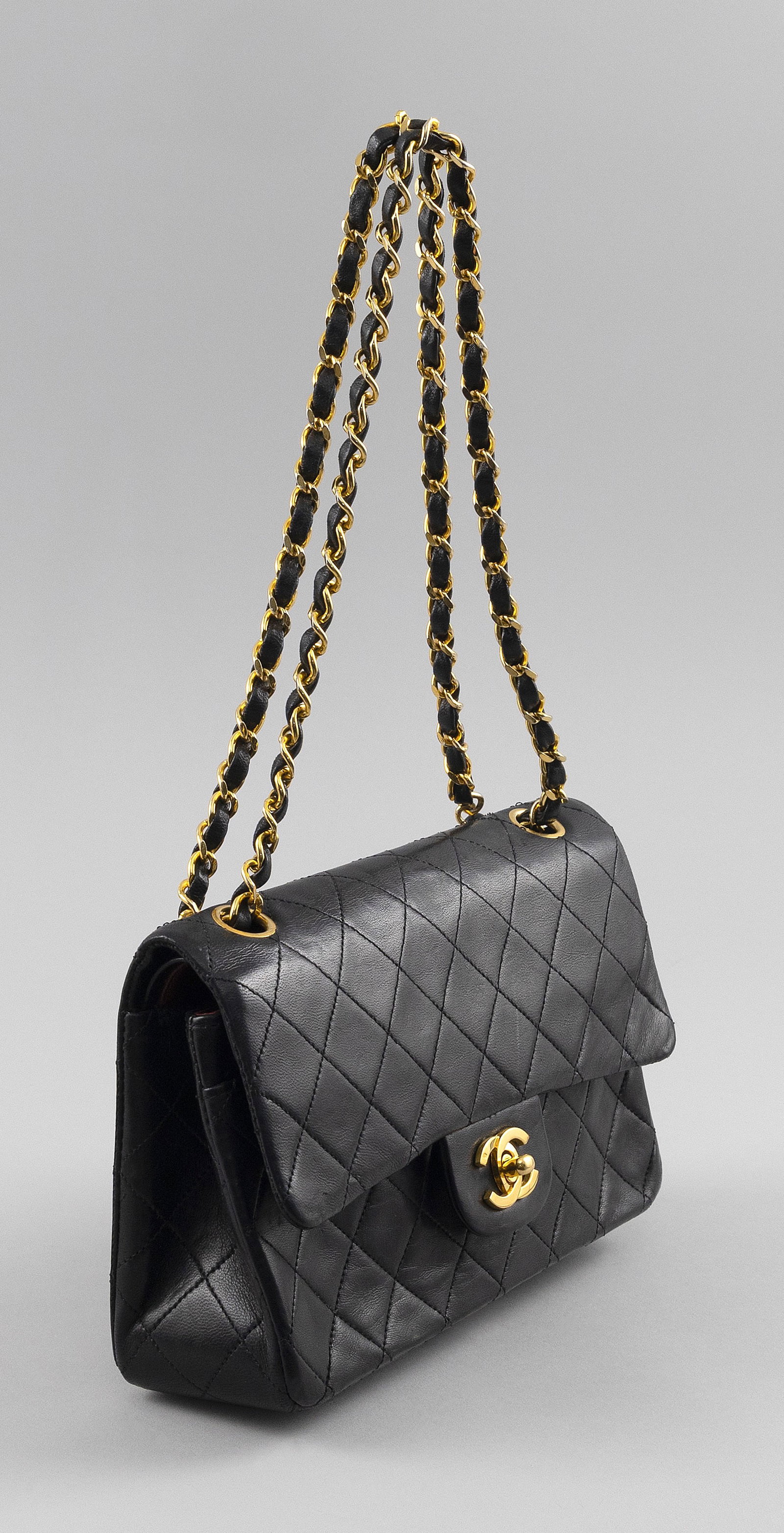 CHANEL CLASSIC MEDIUM QUILTED BLACK LAMBSKIN DOUBLE FLAP BAG 5.5" x 9". Chain with a 17" drop.: CHANEL CLASSIC MEDIUM QUILTED BLACK LAMBSKIN DOUBLE FLAP BAG 24kt gold plated hardware. Intertwined leather and chain shoulder strap. Burgundy leather lining. With felt dust bag. 5.5" x 9". Chain with