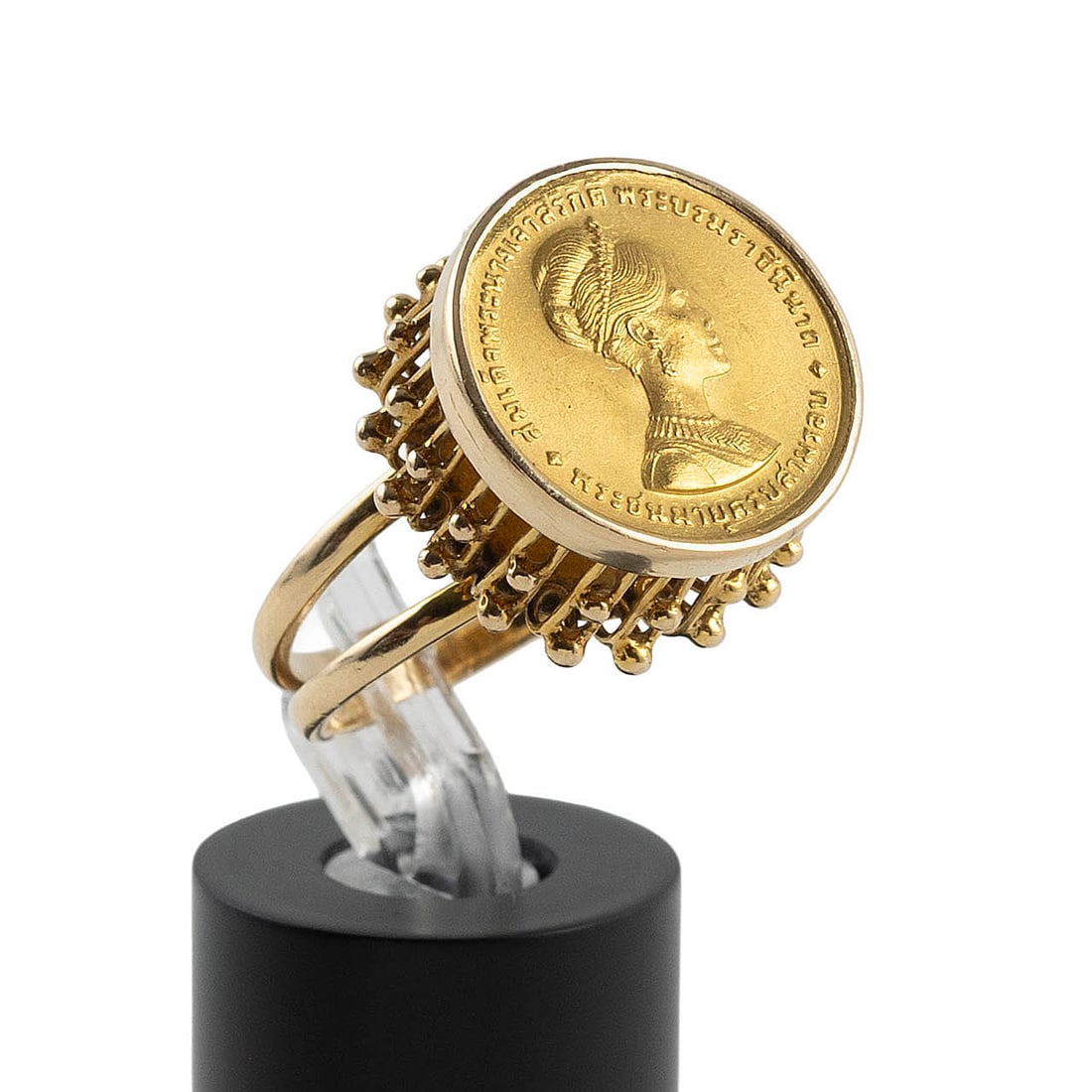 18KT YELLOW GOLD COIN RING Approx. 5.9 total dwt.: 18KT YELLOW GOLD COIN RING 150 Baht Rama IX (Queen SiriKit) coin dated 1968. Coin .900. Stamped. Diameter approx. 19.0mm. Size 5?. Approx. 5.9 total dwt.