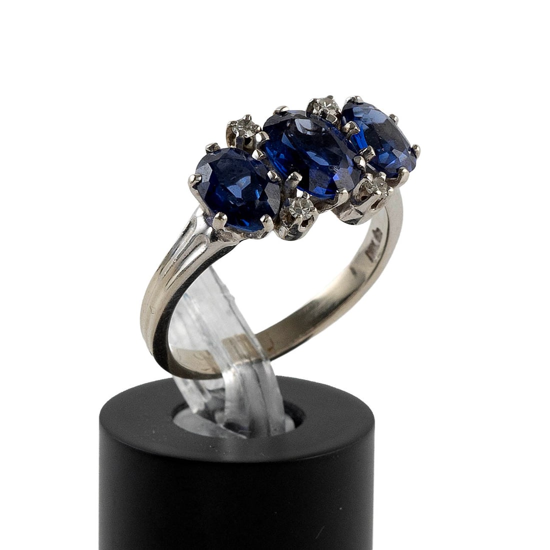 14KT WHITE GOLD, SAPPHIRE AND DIAMOND RING Approx. 2.8 total dwt.: 14KT WHITE GOLD, SAPPHIRE AND DIAMOND RING One approx. 5.0 x 7.0mm oval-cut sapphire flanked by two approx. 4.0 x 6.0mm oval-cut sapphires and four small round-cut diamonds. Stamped. Size 7?. Approx. 