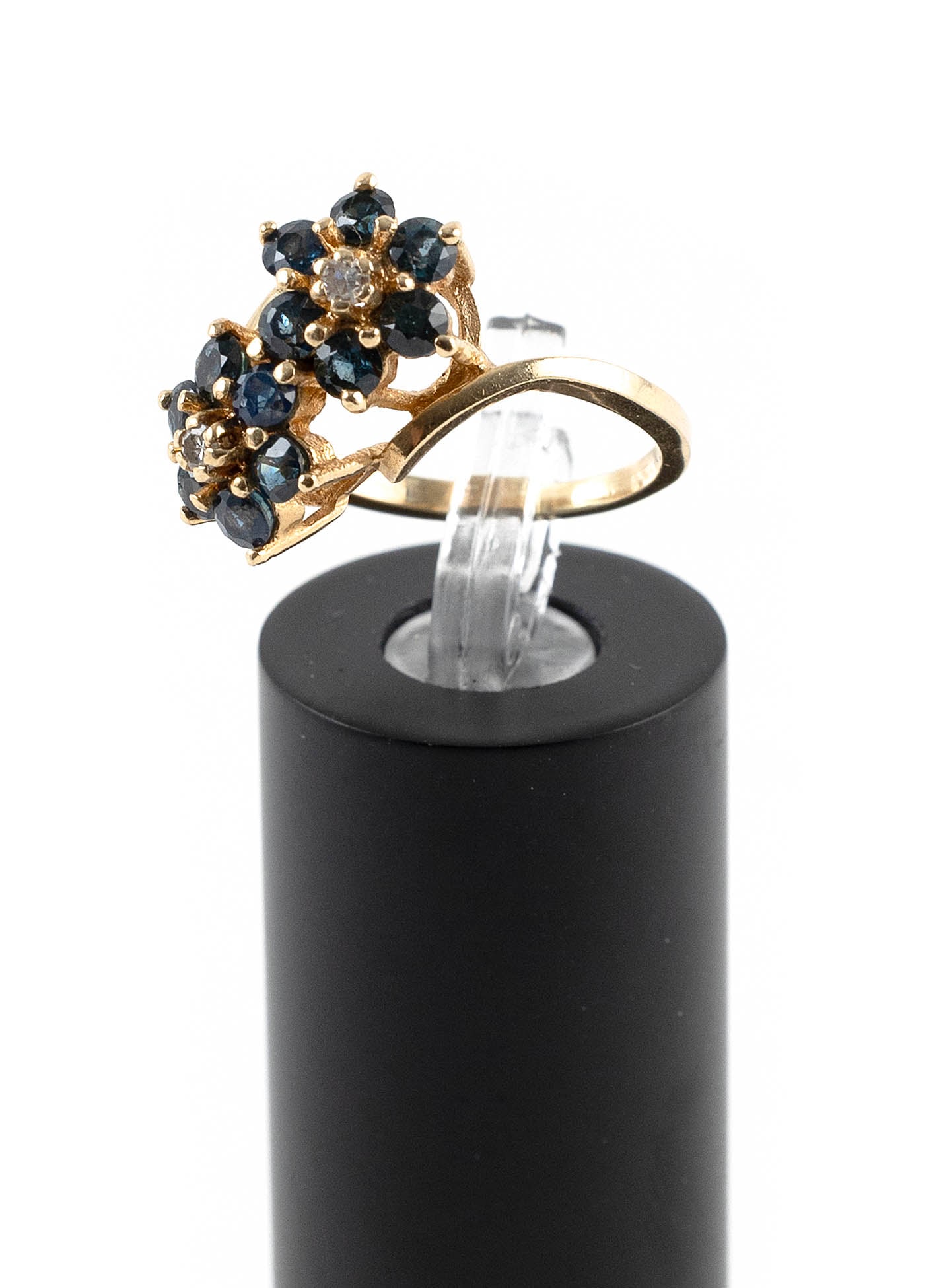 14KT YELLOW GOLD, DIAMOND AND SAPPHIRE RING Approx. 2.4 total dwt.: 14KT YELLOW GOLD, DIAMOND AND SAPPHIRE RING Bypass design with two floriform clusters totaling 12 small round-cut sapphires and two small round-cut diamonds. Stamped. Top approx. 10 x 17mm. Size 5?. A