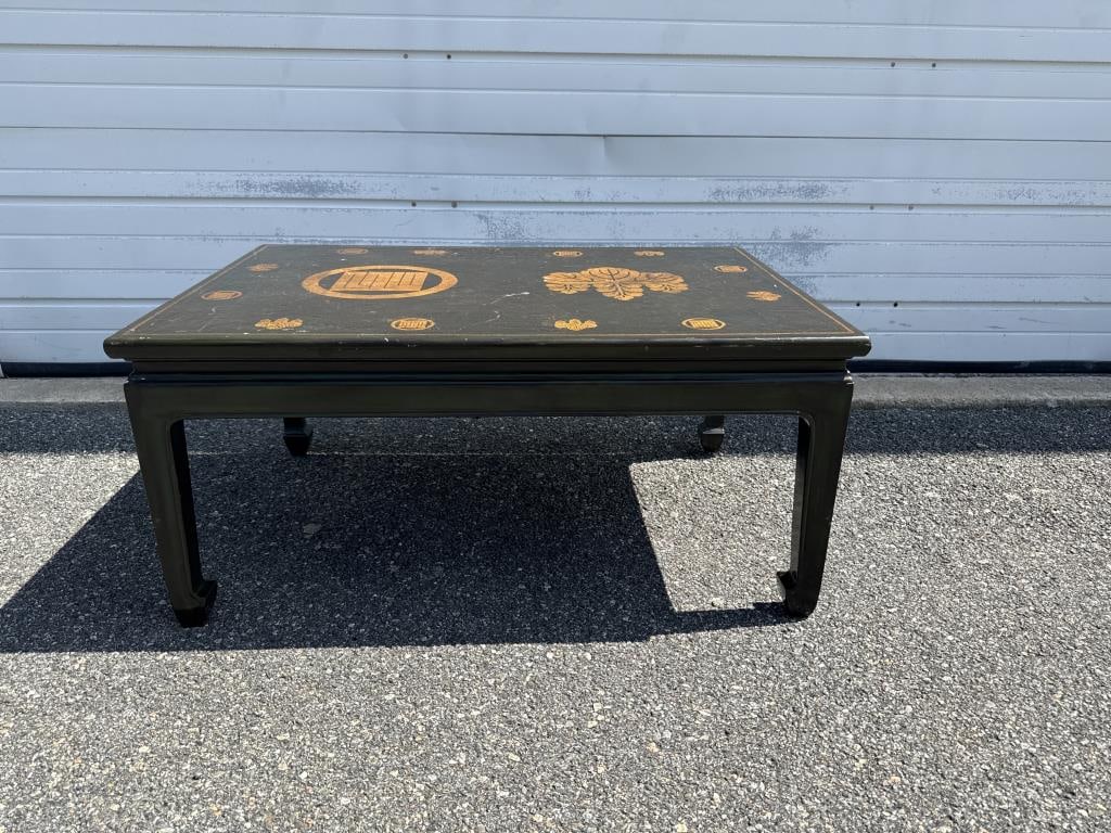 JAPONAISERIE COFFEE TABLE 20th Century Height 17". Length 37". Width 25".: JAPONAISERIE COFFEE TABLE 20th Century Green lacquer top with a gilt paulownia leaf and a square mon surrounded by similar smaller motifs. Coordinating base. Height 17". Length 37". Width 25". Provena