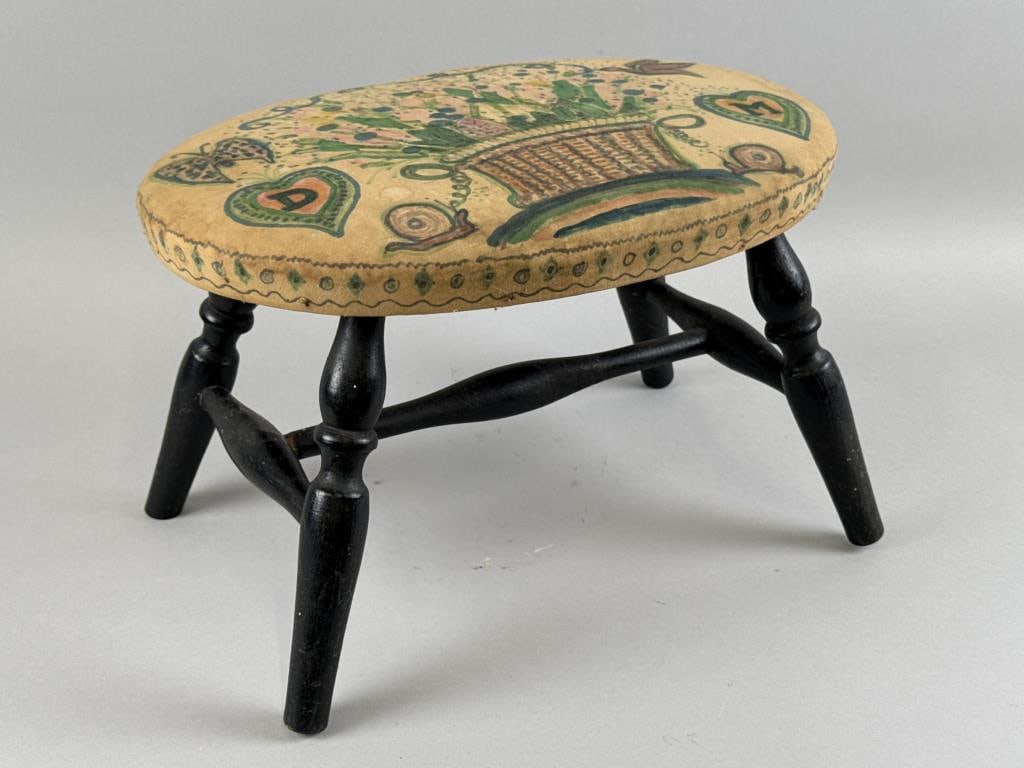 WINDSOR-STYLE FOOTSTOOL 20th Century Height 10.75". Width 15". Depth 11".: WINDSOR-STYLE FOOTSTOOL 20th Century Cushioned top covered in painted linen depicting a basket of flowers, a butterfly, a bird, and "D" and "M" hearts. Height 10.75". Width 15". Depth 11". Provenance: