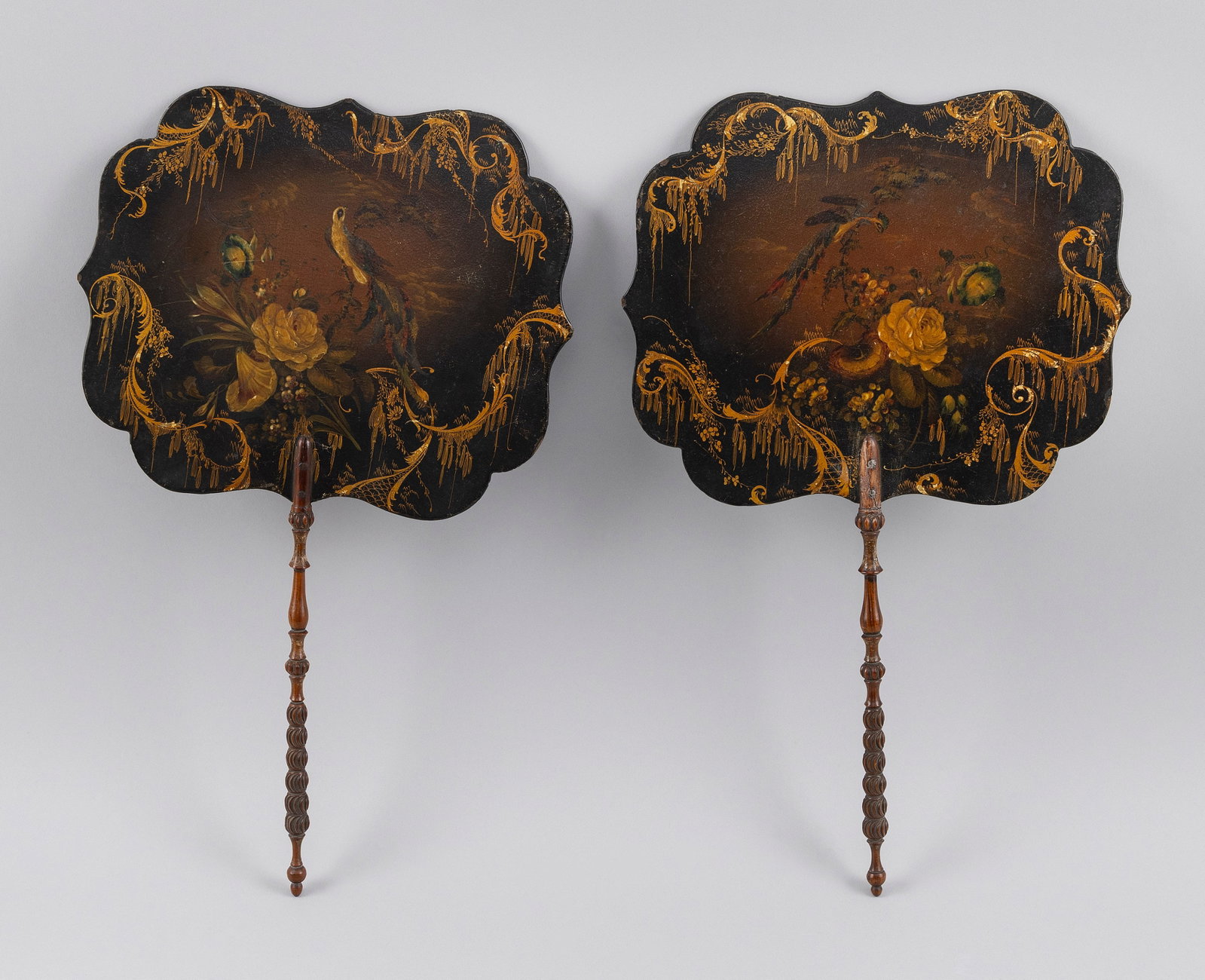 TWO HAND-HELD SCREENS Likely English, Late 19th Century Lengths 15.5". (1 of 2)