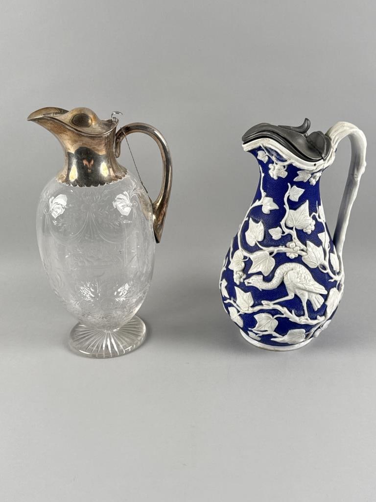 TWO ENGLISH LIDDED JUGS 19th Century: TWO ENGLISH LIDDED JUGS 19th Century 1) Minton Parian jug with decoration of raised white grape vines, grapes and birds against a textured blue ground. Pewter lid. Raised maker's mark on base. Height 