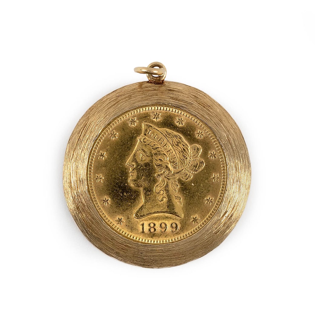 1899 U.S. $10 LIBERTY HEAD GOLD COIN SET IN A 14KT GOLD BEZEL Total approx. 18.7 dwt.: 1899 U.S. $10 LIBERTY HEAD GOLD COIN SET IN A 14KT GOLD BEZEL Bezel with solid back. Stamped 14kt. Total approx. 18.7 dwt.