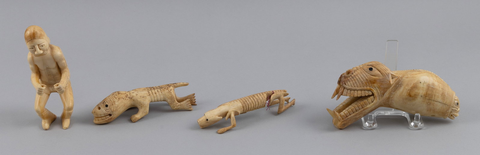 FOUR INUIT CARVED IVORY TUPILAKS Greenland, 20th Century Lengths from 5" to 6.5". (1 of 5)