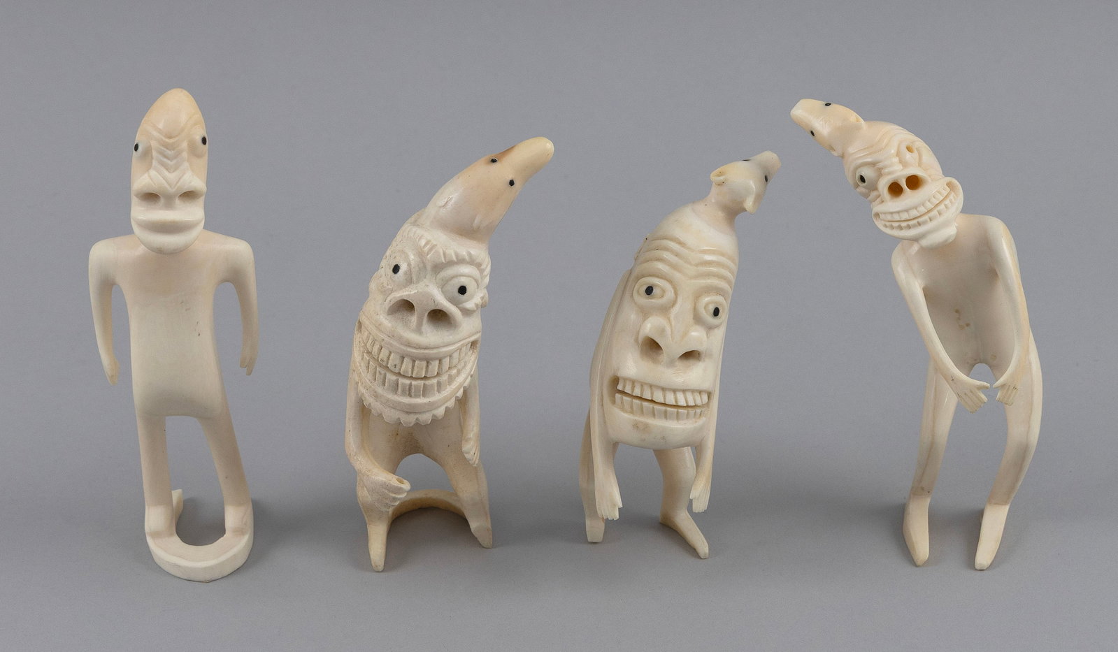 FOUR INUIT CARVED IVORY TUPILAKS Greenland, 20th Century Heights from 4" to 5.75". (1 of 5)