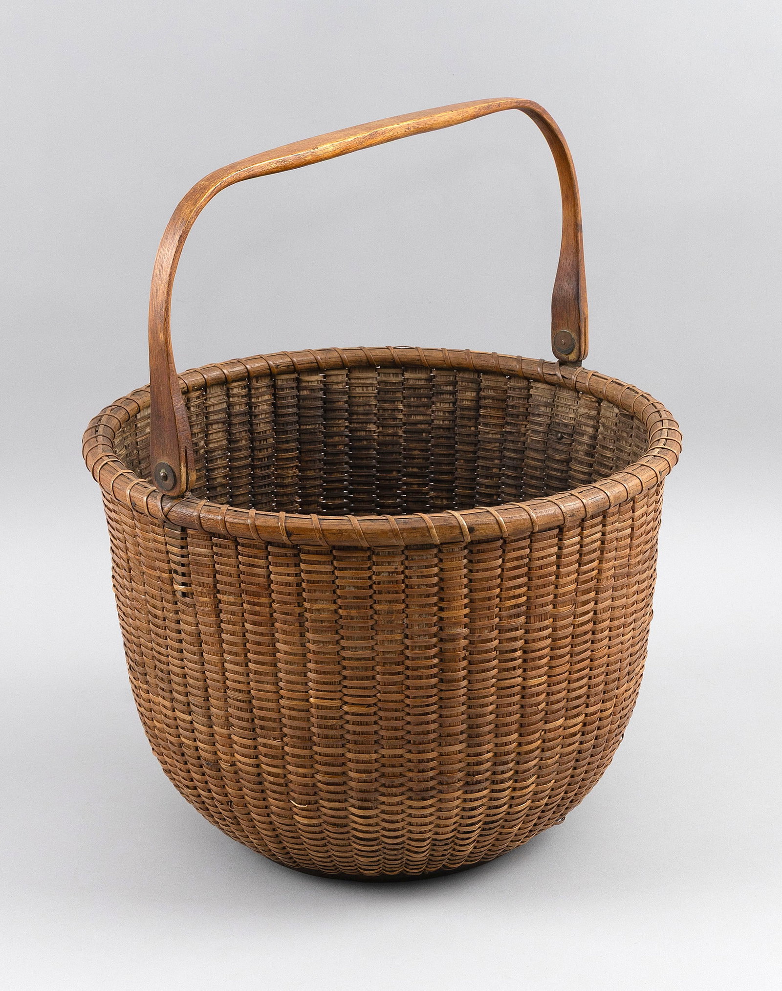 LARGE NANTUCKET BASKET WITH SWING HANDLE Late 19th Century Height to rim 9.25". Diameter 12.75". (1 of 5)