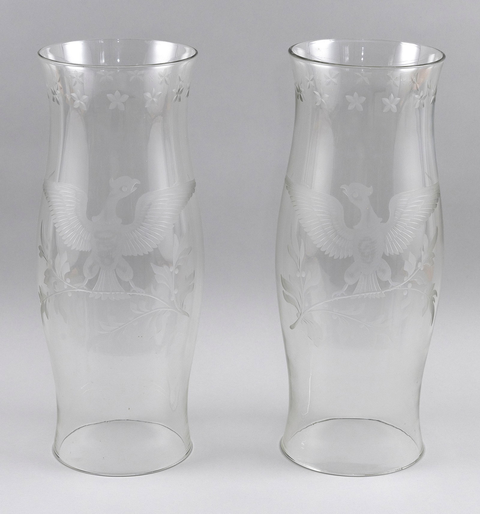 PAIR OF ETCHED GLASS HURRICANES WITH PATRIOTIC DECORATION ETCHED EAGLE AND SWAG DECORATION 20th: PAIR OF ETCHED GLASS HURRICANES WITH PATRIOTIC DECORATION ETCHED EAGLE AND SWAG DECORATION 20th Century Depict an eagle with olive branches at the center and stars around the rims. Heights 14.5".