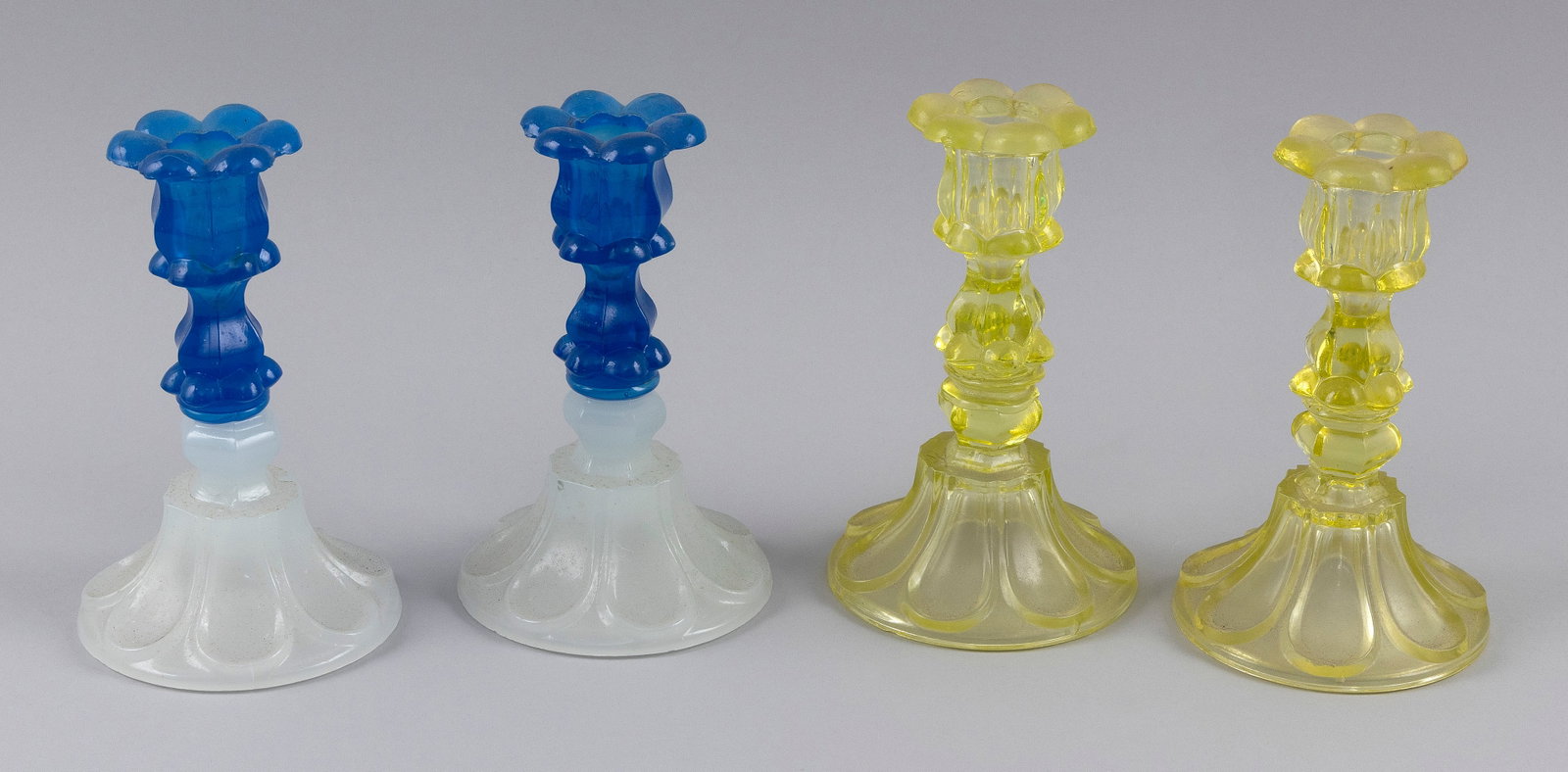 TWO PAIRS OF SANDWICH GLASS CO. LOOP AND PETAL CANDLESTICKS Mid-19th Century Heights approx. 7". (1 of 2)
