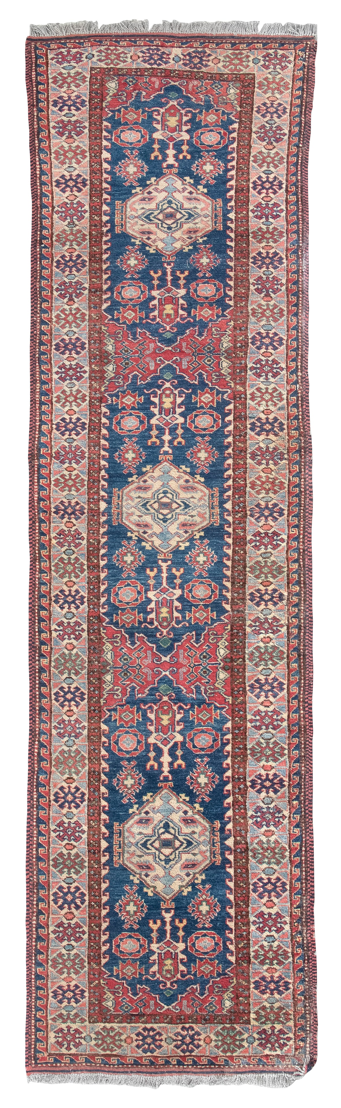 CAUCASIAN DESIGN RUNNER: 2'4" X 8'5" Late 20th or Early 21st Century: CAUCASIAN DESIGN RUNNER: 2'4" X 8'5" Late 20th or Early 21st Century Traditional red, blue, ivory and subtle green and pink geometric medallions and various stylized elements repeat in sequence throug