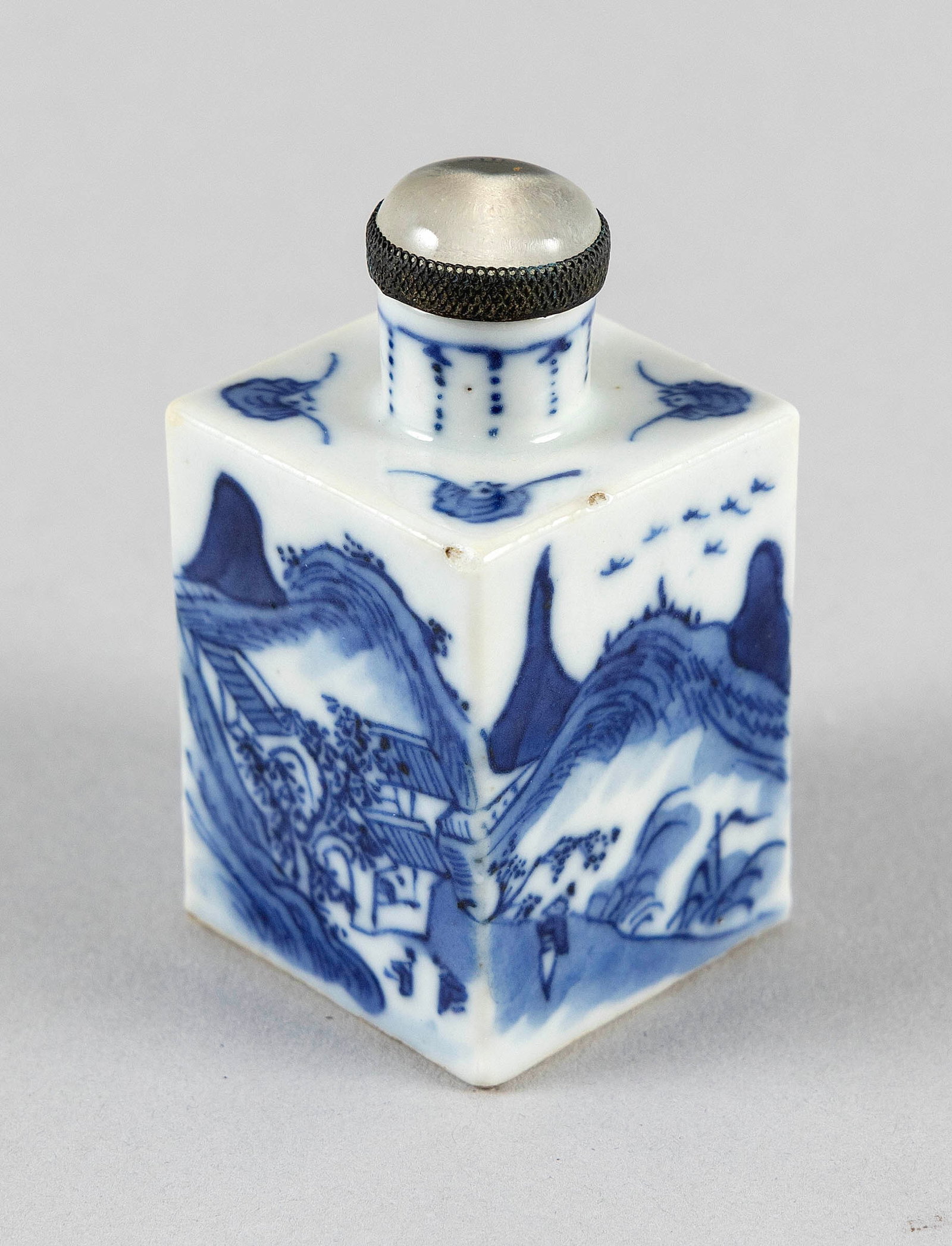 CHINESE BLUE AND WHITE PORCELAIN SNUFF BOTTLE 18th/19th Century Height 2.5".: CHINESE BLUE AND WHITE PORCELAIN SNUFF BOTTLE 18th/19th Century Rectangular body with continuous landscape decoration. Bat decoration at shoulder. Old label on base. Height 2.5". Provenance: Arnold Co