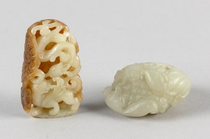 TWO CHINESE CARVED WHITE JADE PEBBLES