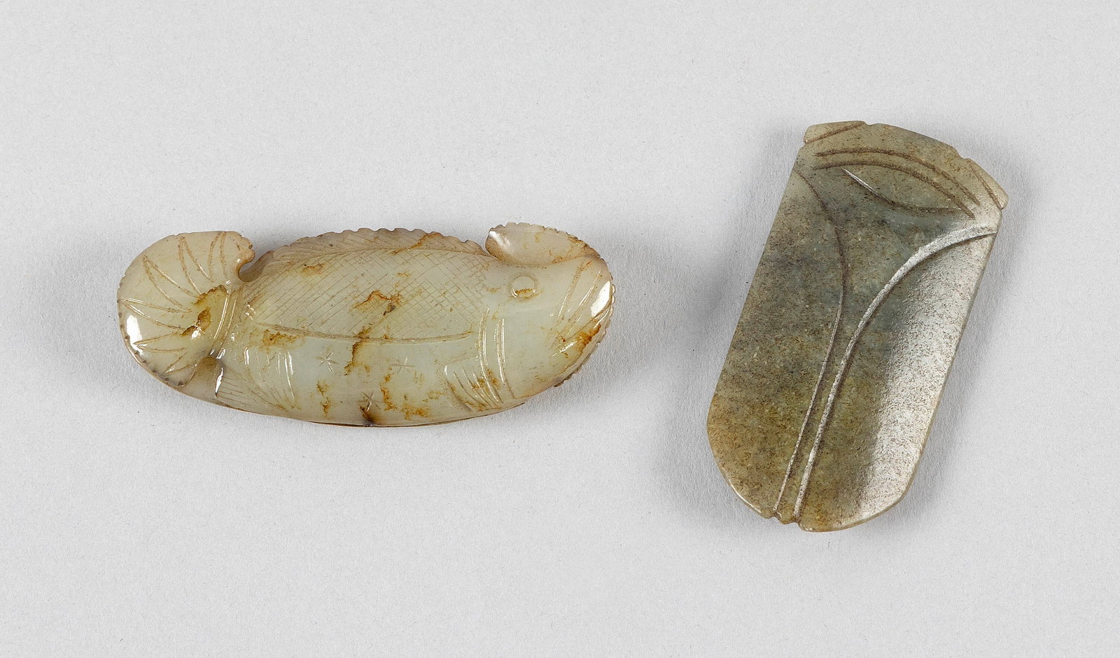 TWO ARCHAIC-STYLE CELADON AND GREEN JADE PENDANTS (1 of 2)