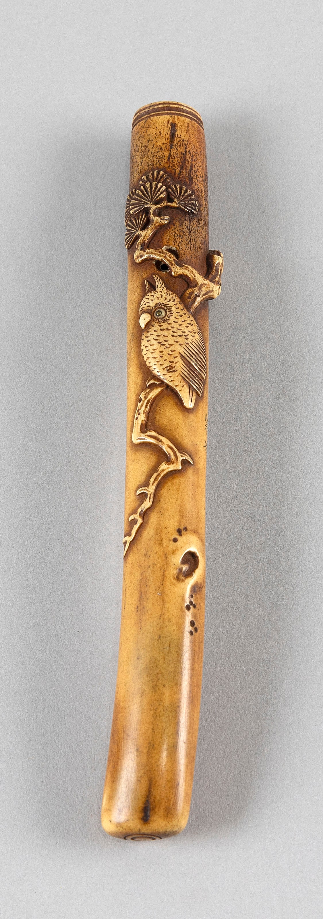 JAPANESE STAG ANTLER KISERU BY SOYA 19th Century Length 8.25".: JAPANESE STAG ANTLER KISERU BY SOYA 19th Century Carved design of an owl with double inlaid eyes sitting on a leafy branch. Signed on side. Length 8.25".