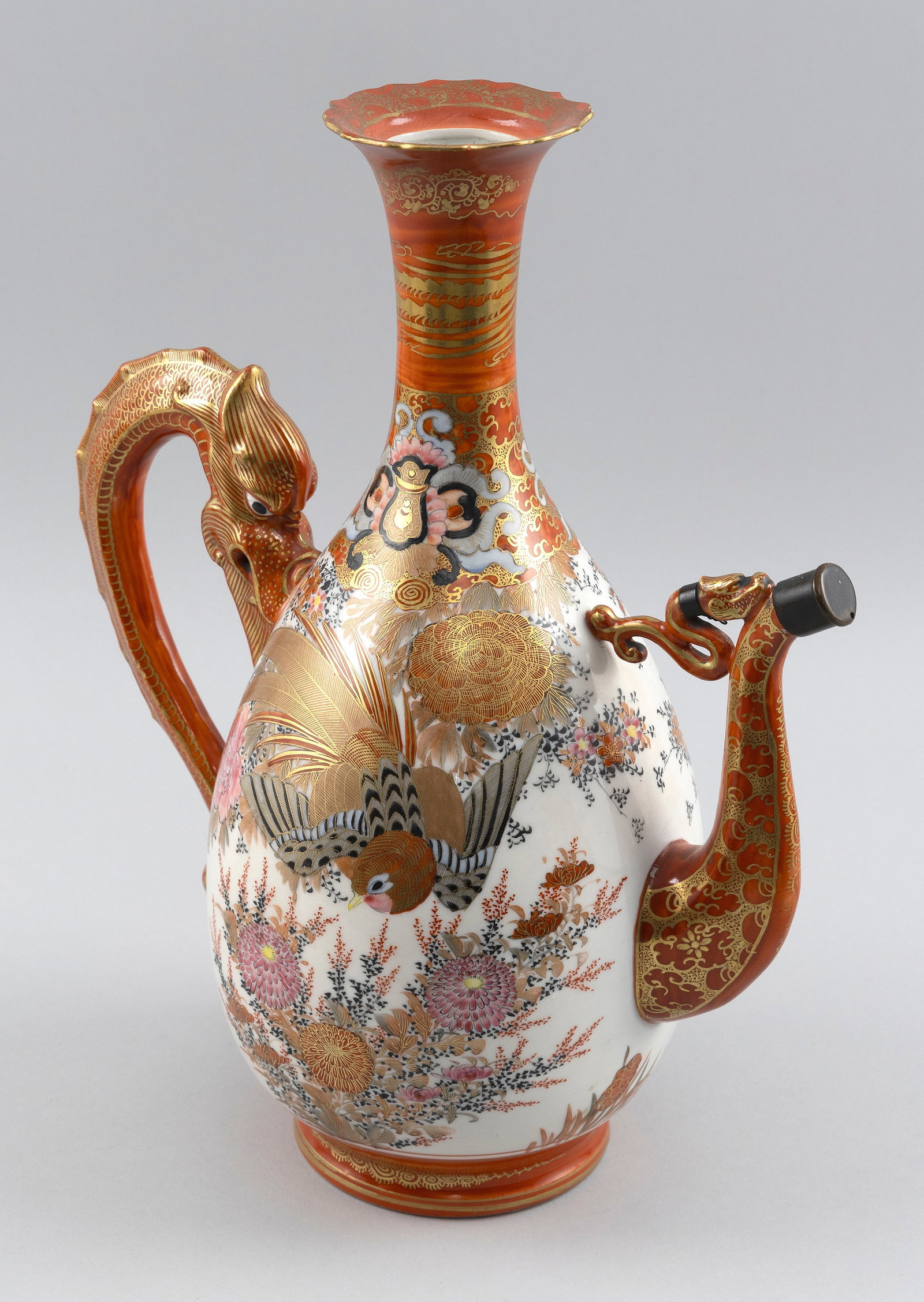 JAPANESE KUTANI PORCELAIN EWER Late 19th/Early 20th Century Height 13.5".: JAPANESE KUTANI PORCELAIN EWER Late 19th/Early 20th Century Pear-shaped with an orange and gilt glaze dragon-form handle and spout. Decoration of birds against a floral-filled ground. Marked on base. 