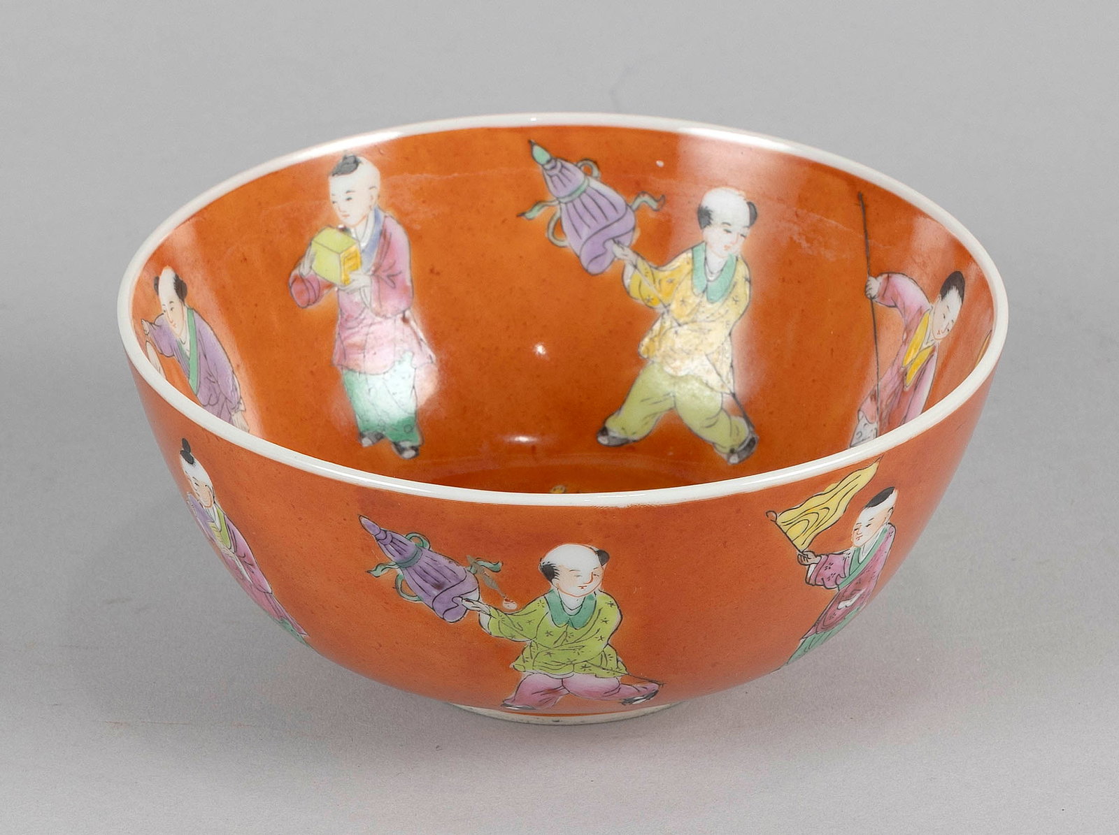 CHINESE FAMILLE ROSE PORCELAIN BOWL 19th Century Height 2.75". Diameter 6".: CHINESE FAMILLE ROSE PORCELAIN BOWL 19th Century Both interior and exterior depict children holding objects and engaged in various pursuits against an orange ground. Height 2.75". Diameter 6".
