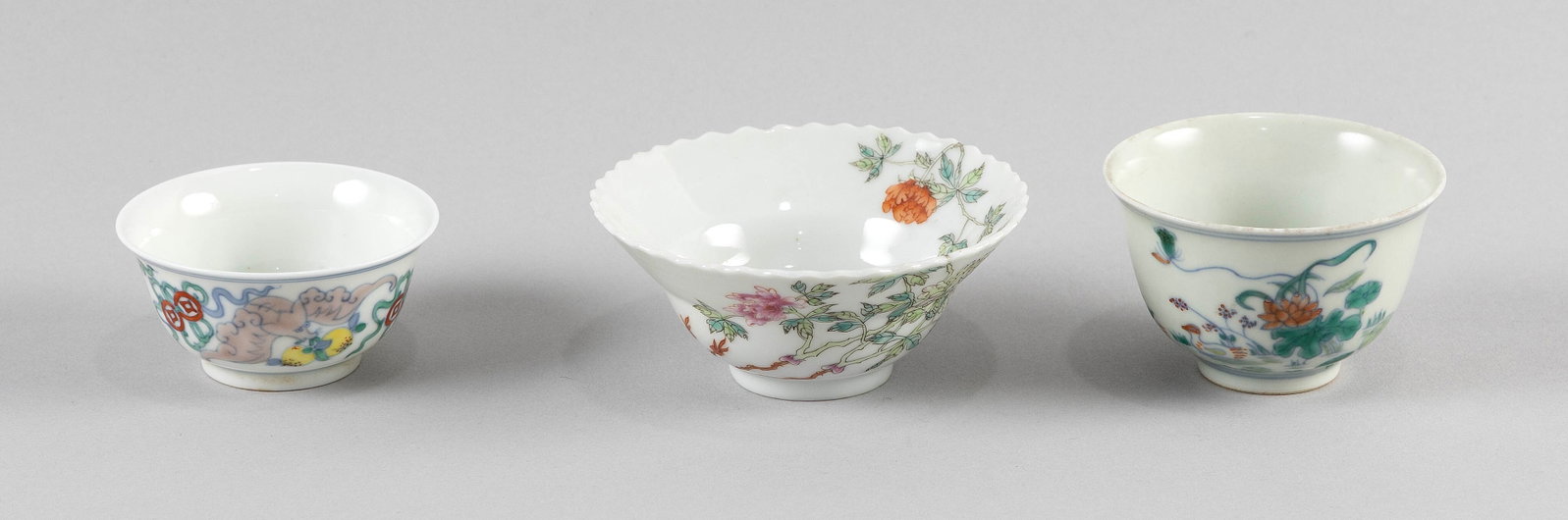 THREE CHINESE PORCELAIN CUPS 19th Century: THREE CHINESE PORCELAIN CUPS 19th Century 1) Famille rose with flared and shaped rim and decoration of floral sprigs. Four-character "Le Shan Tang Zhi" mark on base. Height 1.5". Diameter 3.75". 2-3) 