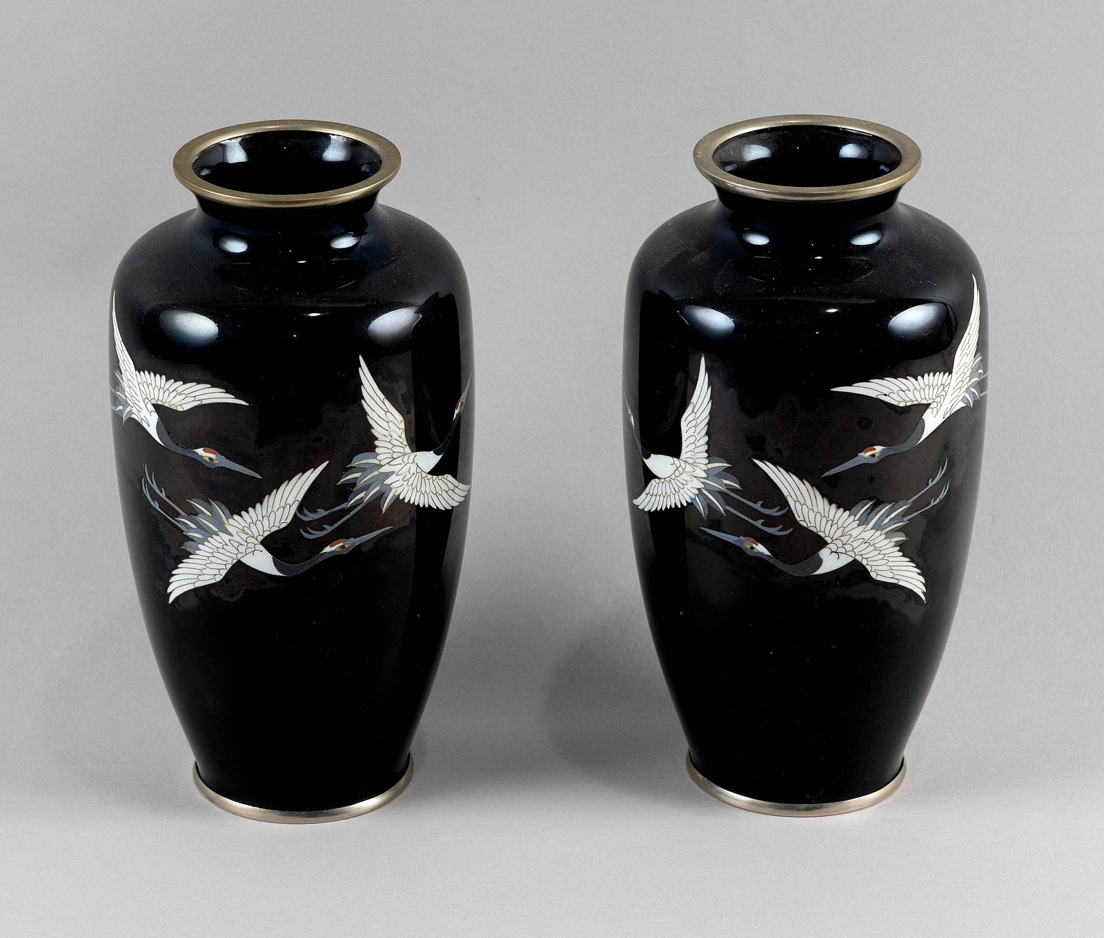 PAIR OF JAPANESE CLOISONNE ENAMEL BALUSTER VASES Early 20th Century Height 7.5".: PAIR OF JAPANESE CLOISONNE ENAMEL BALUSTER VASES Early 20th Century Decorated with three white cranes on a midnight ground. Silver foot rim marked "Japan Sato". Height 7.5".