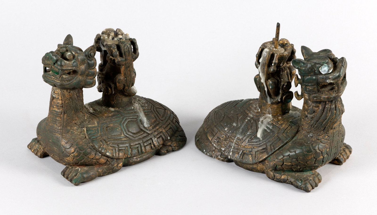 PAIR OF CHINESE GILTWOOD LONGGUI PRICKET CANDLESTICKS Late 19th Century Heights 8.5". Lengths 8".: PAIR OF CHINESE GILTWOOD LONGGUI PRICKET CANDLESTICKS Late 19th Century Carved as two kylin climbing a ruyi-form shaft atop the carapaces. Heights 8.5". Lengths 8".