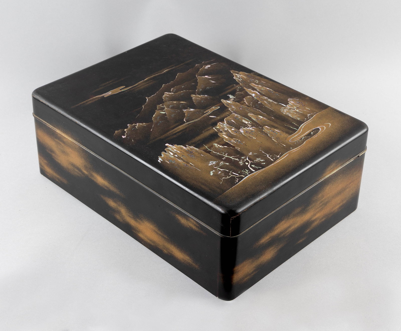 JAPANESE BLACK AND GILT LACQUER KIMONO BOX Meiji Period Height 6". Width 11". Depth 16".: JAPANESE BLACK AND GILT LACQUER KIMONO BOX Meiji Period Cover with a mountain and river landscape highlighted with mother-of-pearl. Nashiji interior. Height 6". Width 11". Depth 16".