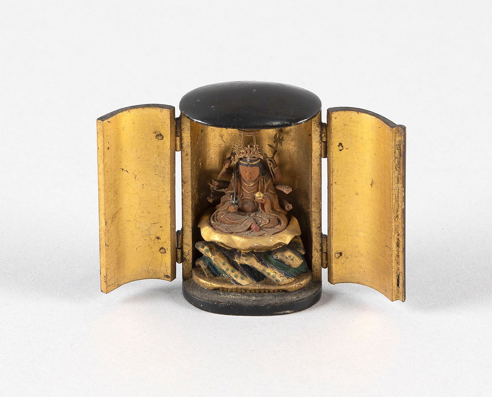 JAPANESE BLACK LACQUER MINIATURE ZUSHI (TRAVELING SHRINE) Meiji Period Height 2".: JAPANESE BLACK LACQUER MINIATURE ZUSHI (TRAVELING SHRINE) Meiji Period Opens to reveal a seated deity on a lotus base over rockery. Height 2".
