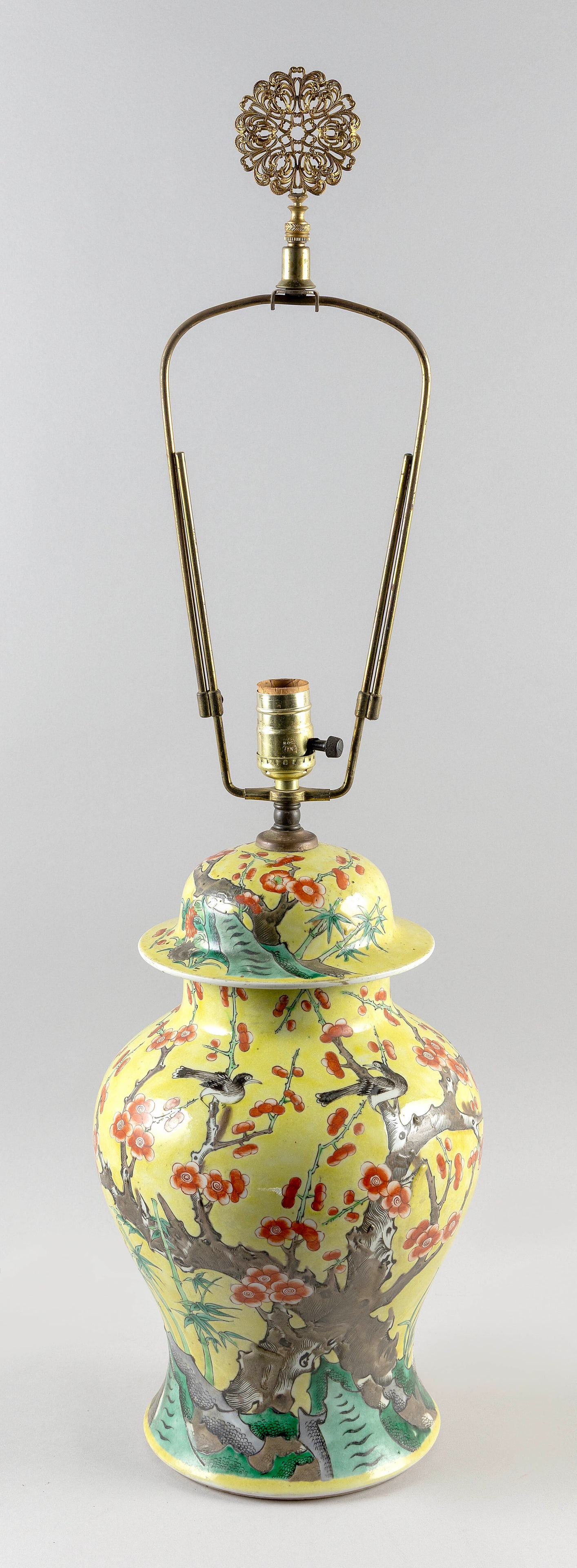 CHINESE FAMILLE JAUNE PORCELAIN COVERED JAR 19th Century Jar height 17".: CHINESE FAMILLE JAUNE PORCELAIN COVERED JAR 19th Century Decoration of birds in flowering tree branches and rockery against a yellow ground. Conforming domed cover. Mounted as a table lamp. Jar height