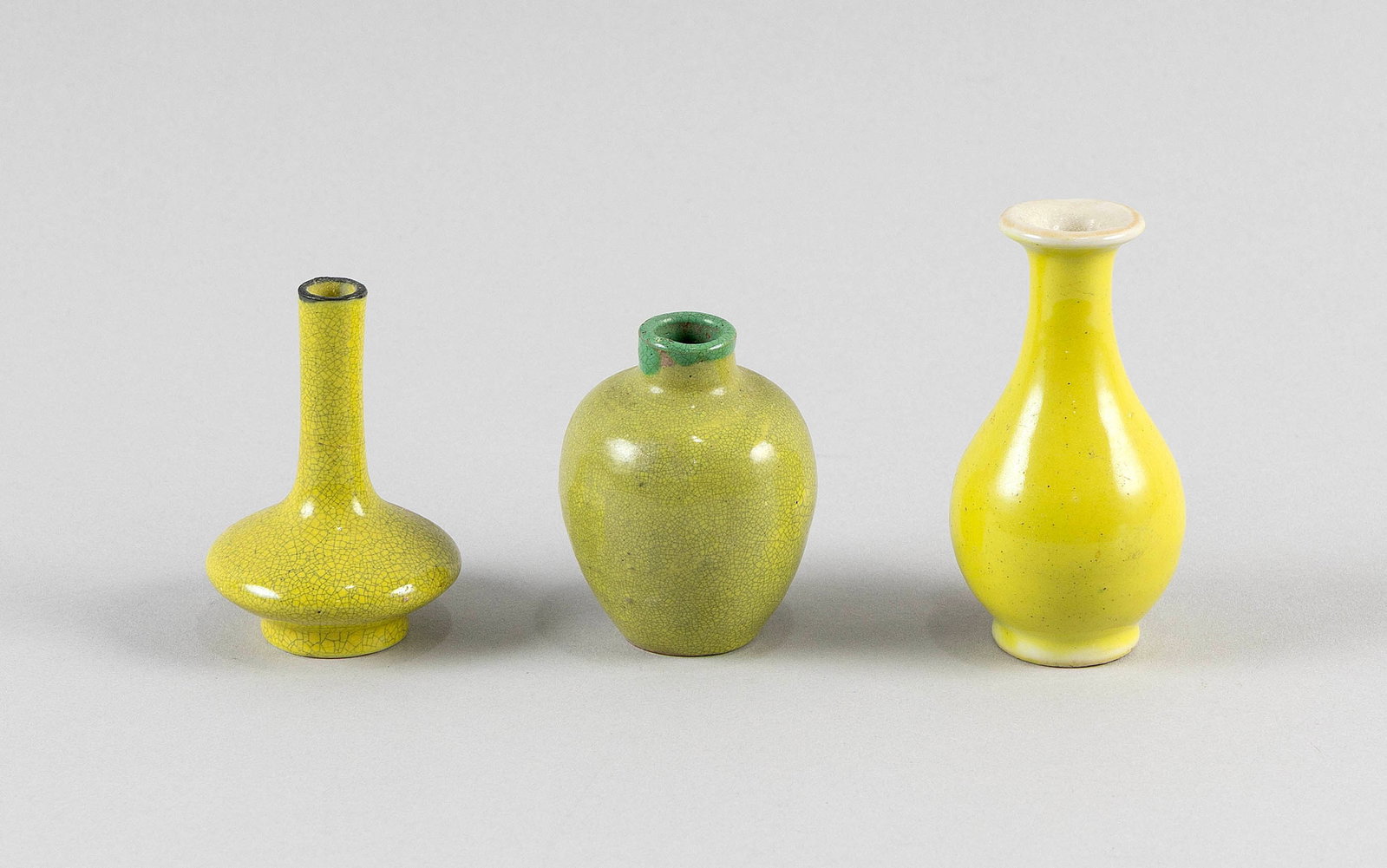 THREE CHINESE YELLOW GLAZE PORCELAIN MINIATURE VASES 19th Century or Earlier Heights from 2.25" to: THREE CHINESE YELLOW GLAZE PORCELAIN MINIATURE VASES 19th Century or Earlier Forms and glazes vary. Heights from 2.25" to 3.75".