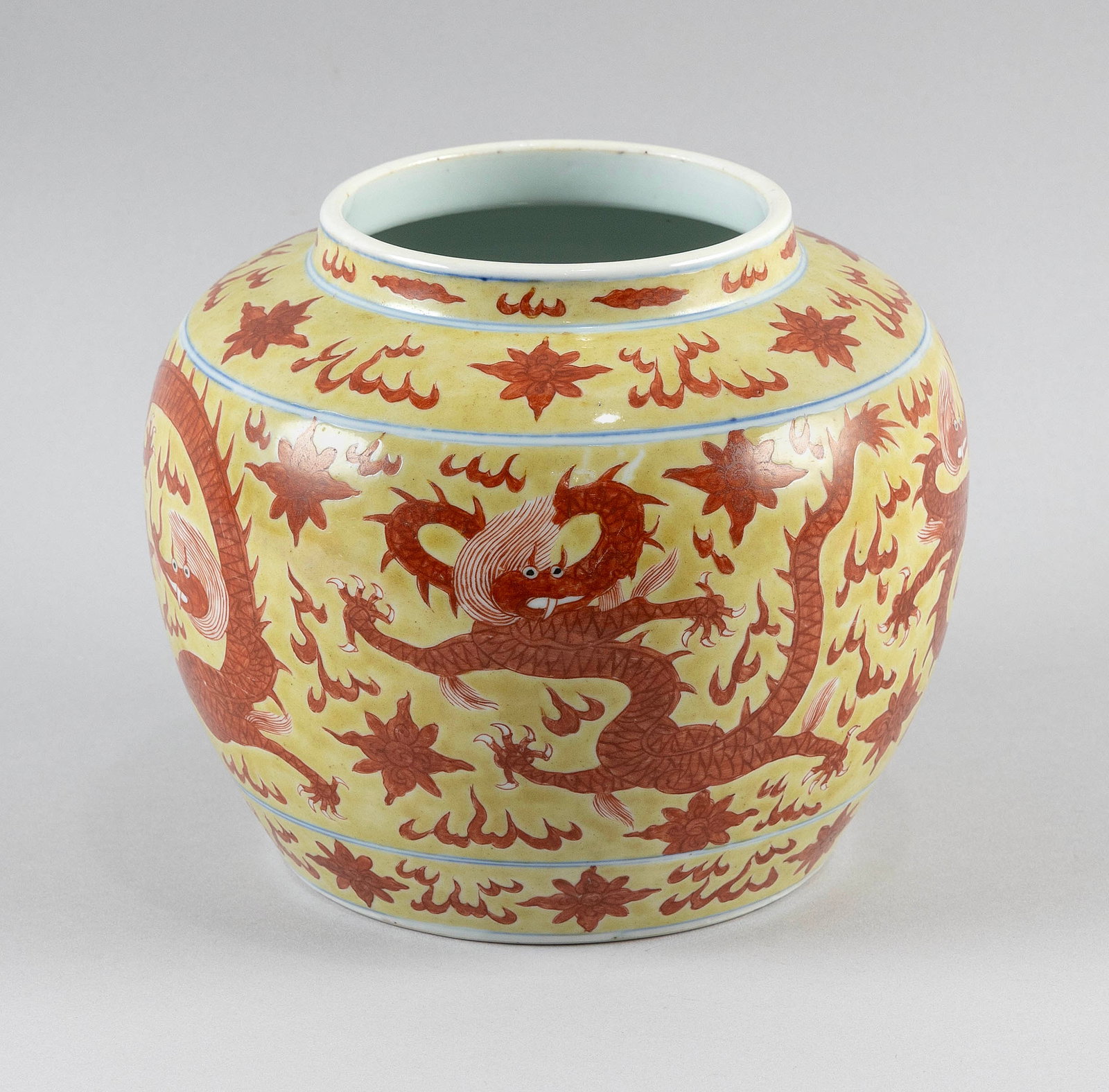 CHINESE IRON RED ENAMEL ON YELLOW GLAZE PORCELAIN GLOBULAR JAR Late 19th Century Height 7". With: CHINESE IRON RED ENAMEL ON YELLOW GLAZE PORCELAIN GLOBULAR JAR Late 19th Century Decoration of five-clawed dragons chasing fiery pearls against a cloud-filled ground. Six-character Wanli mark on base.