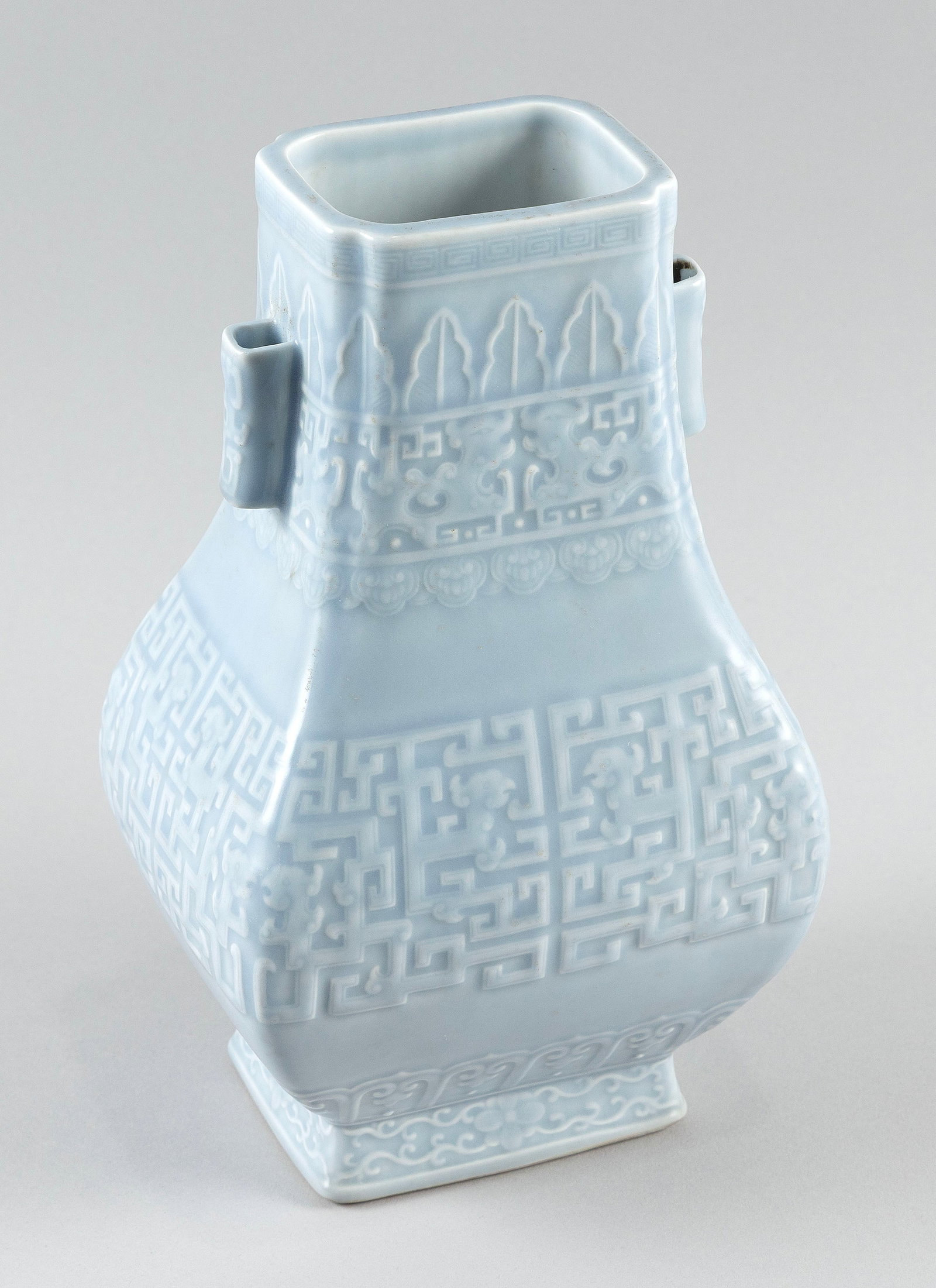 CHINESE CLAIR-DE-LUNE GLAZE PORCELAIN GU-FORM VASE Late 19th/Early 20th Century Height 11".: CHINESE CLAIR-DE-LUNE GLAZE PORCELAIN GU-FORM VASE Late 19th/Early 20th Century Molded dragon, phoenix and key fret decoration. Two lug handles at neck. Slightly raised foot. Six-character Qialong mar