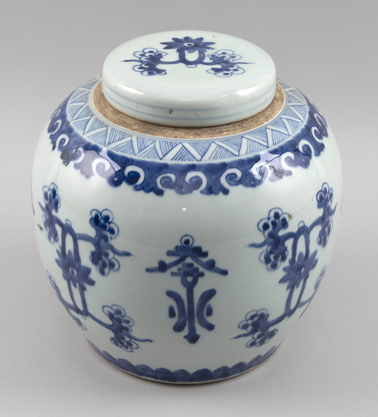 CHINESE BLUE AND WHITE PORCELAIN GINGER JAR Late 19th Century Height 9".: CHINESE BLUE AND WHITE PORCELAIN GINGER JAR Late 19th Century Conforming cover. Stylized floral, vine and symbol decoration about the body. Double foot ring. Height 9".