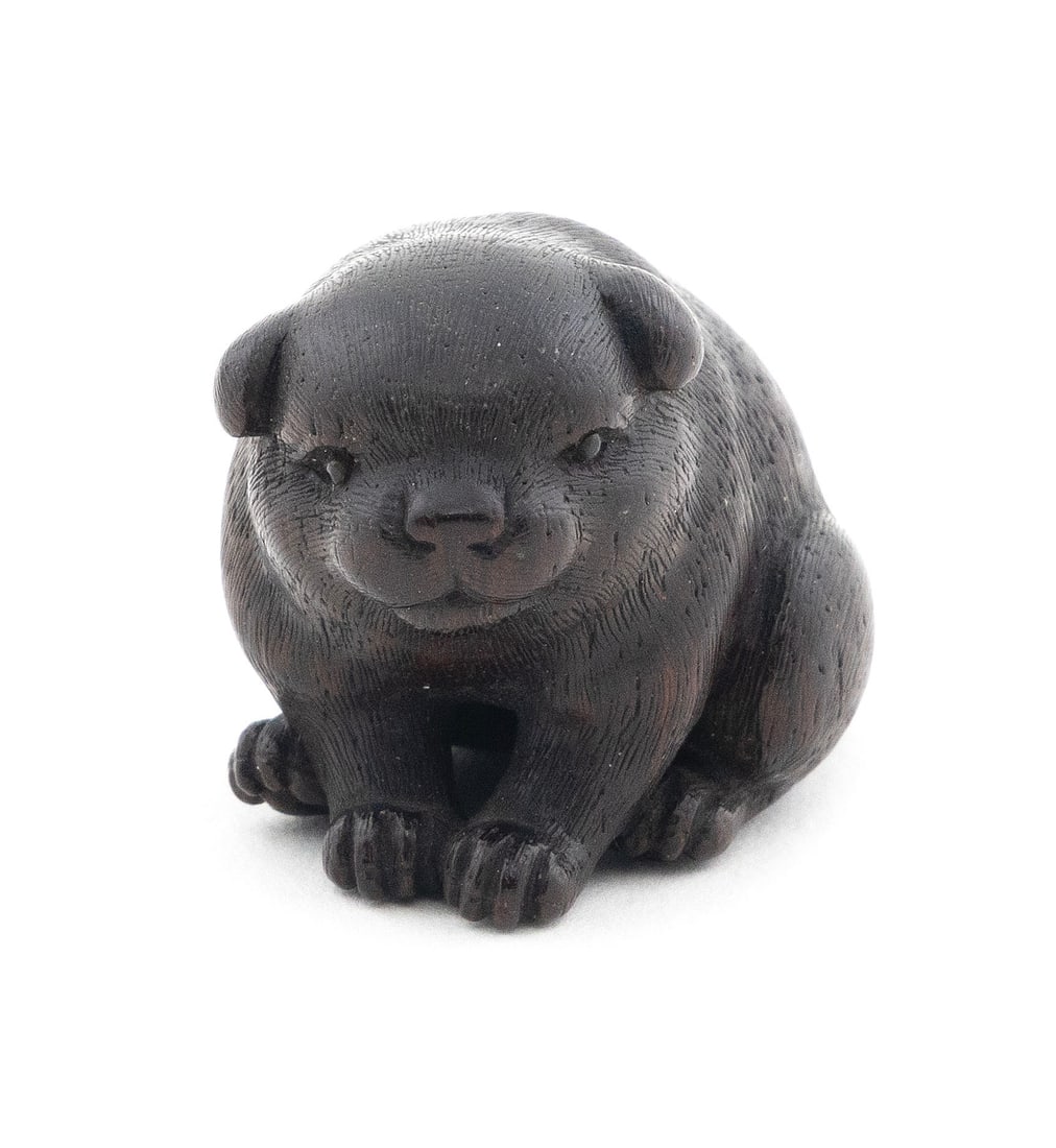 EXQUISITE JAPANESE KYOTO SCHOOL WOOD NETSUKE BY OKATOMO 18th Century Height 1". Length 1.375".: EXQUISITE JAPANESE KYOTO SCHOOL WOOD NETSUKE BY OKATOMO 18th Century A round puppy sitting up with a slightly curved back. Wonderful face with floppy ears, fine inlaid eyes and a round snout showing a