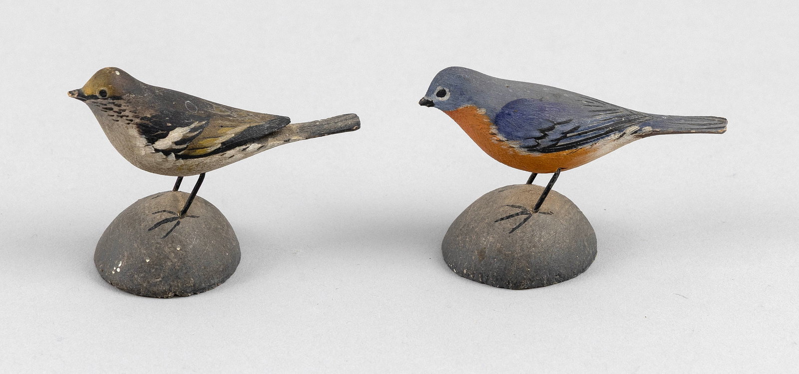 TWO A. ELMER CROWELL MINIATURE SONGBIRDS East Harwich, Massachusetts, 1862-1952 Heights 2".: TWO A. ELMER CROWELL MINIATURE SONGBIRDS East Harwich, Massachusetts, 1862-1952 Circa 1925. A bluebird and a mockingbird, both mounted on round bases. Heights 2".
