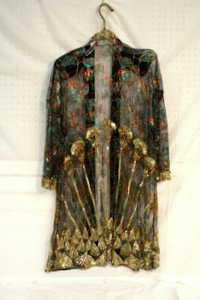 Vintage Sequin & Mesh Ladies Smoking Jacket: Vintage sequin and mesh ladies smoking jacket with floral design. Floral design in shades of turquoise, green, red and gold with intricate beadwork throughout. Sequin and beadwork trim. Measurement fr