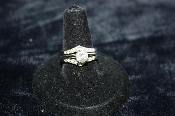 14kt White Gold Diamond Ring w/Diamond Jacket: Approx .70pt slightly off white diamond in 14kt white gold setting. Includes 14kt "wedding jacket" with 18 diamond chips. Diamond has minor inclusions. Size 5.75. 3.6dwt