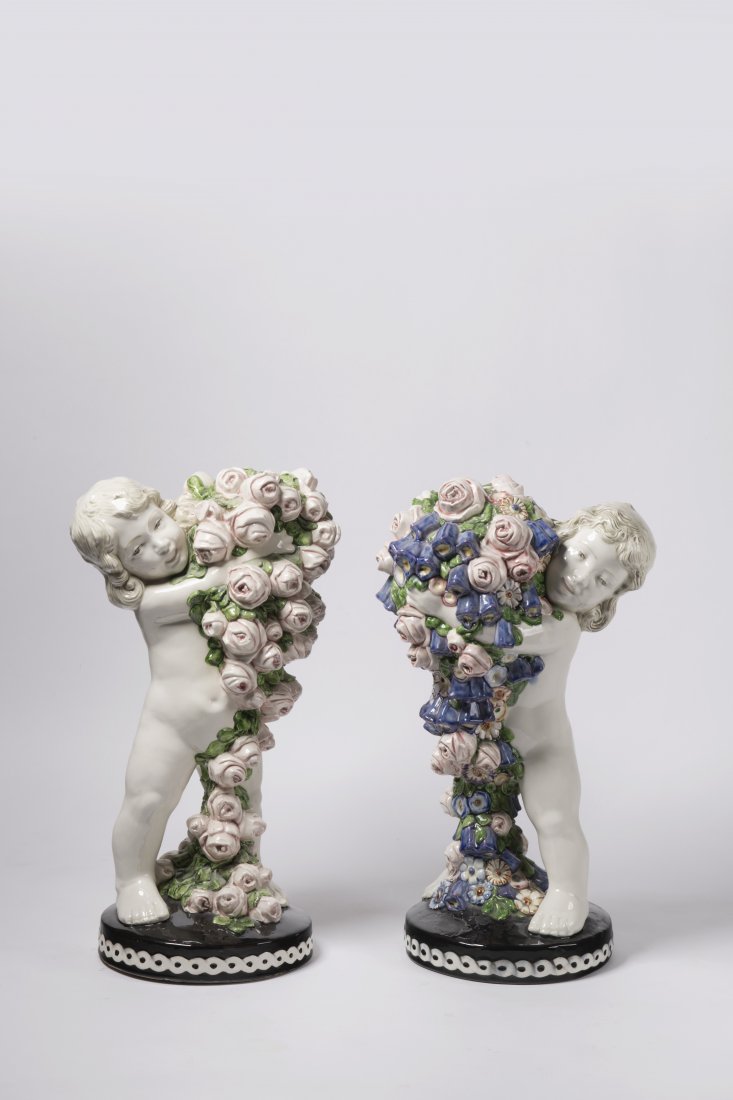 Carl Klimt (1876-1945), A Pair of Candlesticks, Putti: Ceramic, natural white body, painted in colors. Height 48,5 cm.