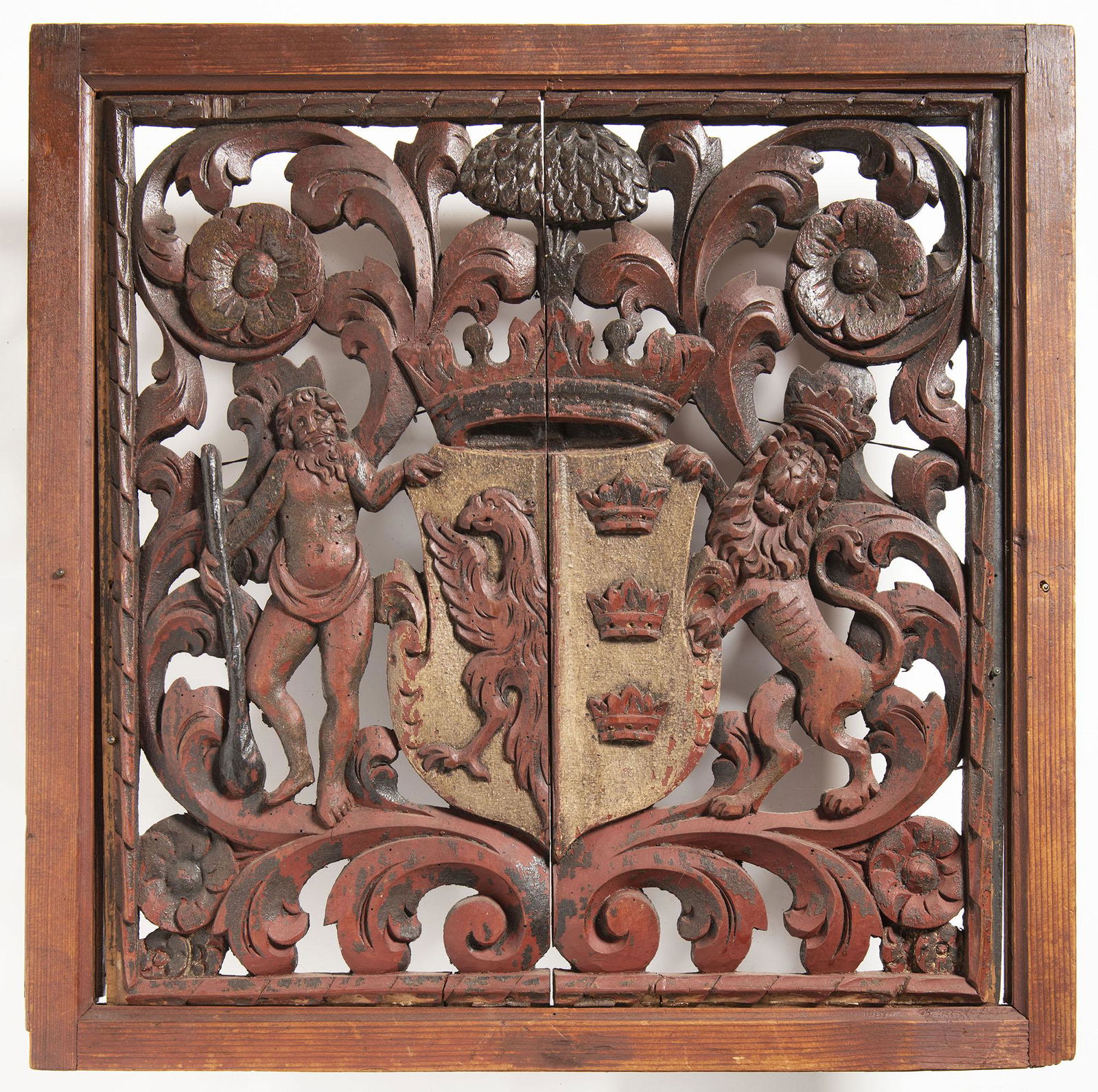 Barock Coat of Arms, 17th Century: Relief, sculpted and pierced in wood and painted. The coat of arms with half a griffin and three crowns is held by a lion and an old man. In a square frame, surrounded by leaves and flowers, in two pa
