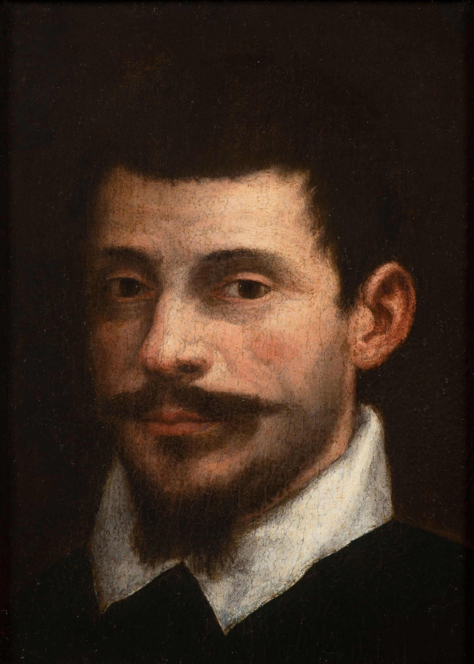 Annibale Carracci, 1560 Bologna - 1609 Rome. PORTRAIT OF A YOUNG MAN: The sitter with black hair, lip and chin beard, white shirt collar over a black doublet, his gaze directed vividly towards the viewer, the background completely darkened. Comparative examples of other