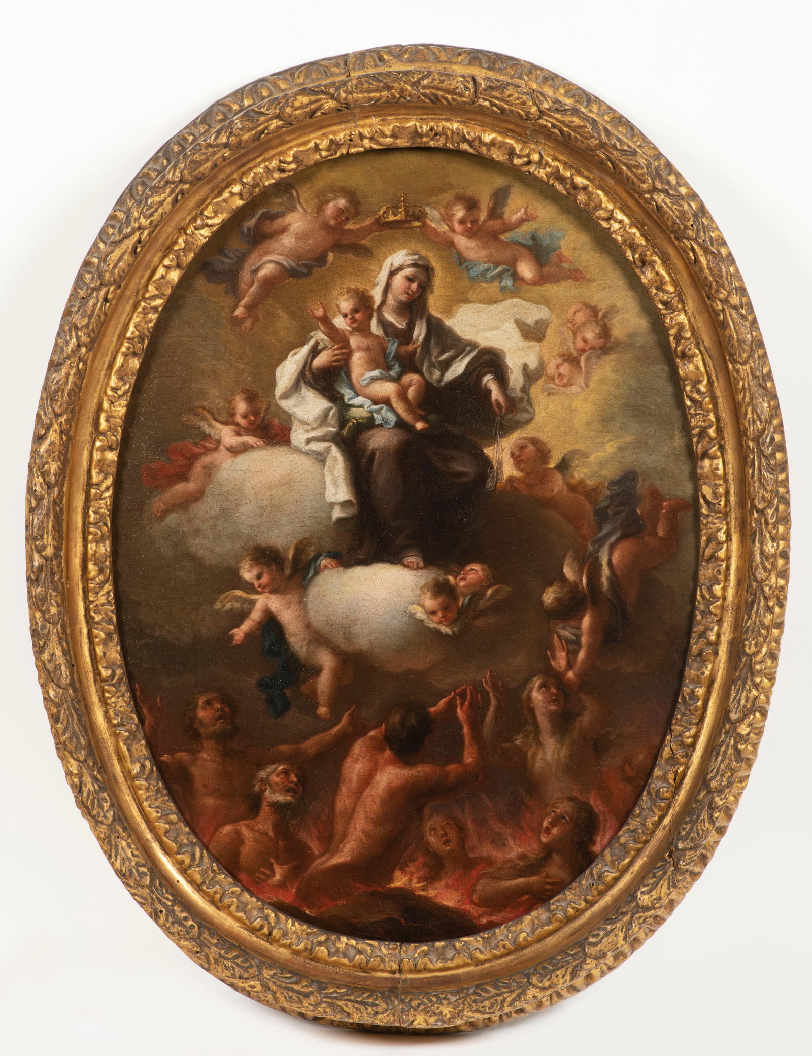 Francesco de Mura( 1696 – 1782): Mary enthroned on clouds in the heavenly realm, holding the infant Jesus in her right hand and several amulets in her downward-facing left hand. Hovering above her are two putti with a crown, thus ide