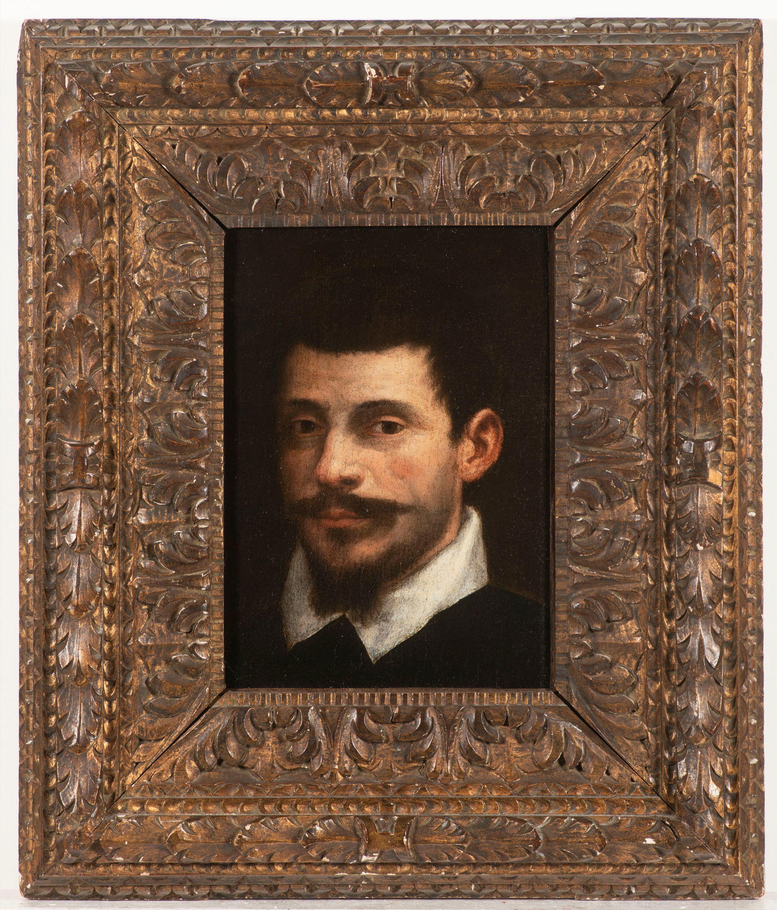 Annibale Carracci, (1560 Bologna - 1609 Rome).: The sitter with black hair, lip and chin beard, white shirt collar over a black doublet, his gaze directed vividly towards the viewer, the background completely darkened. Comparative examples of other