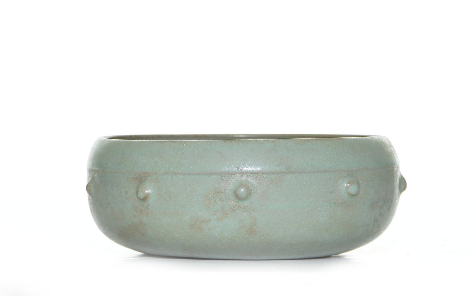 A RARE CHINESE GUANYAO PORCELAIN WASHER: Ming dynasty (1368 - 1644). Of compressed bud form, with a round concaved foot, decorated with evenly spaced bosses around the middle section, covered all in a lavender glaze with characteristic Guany