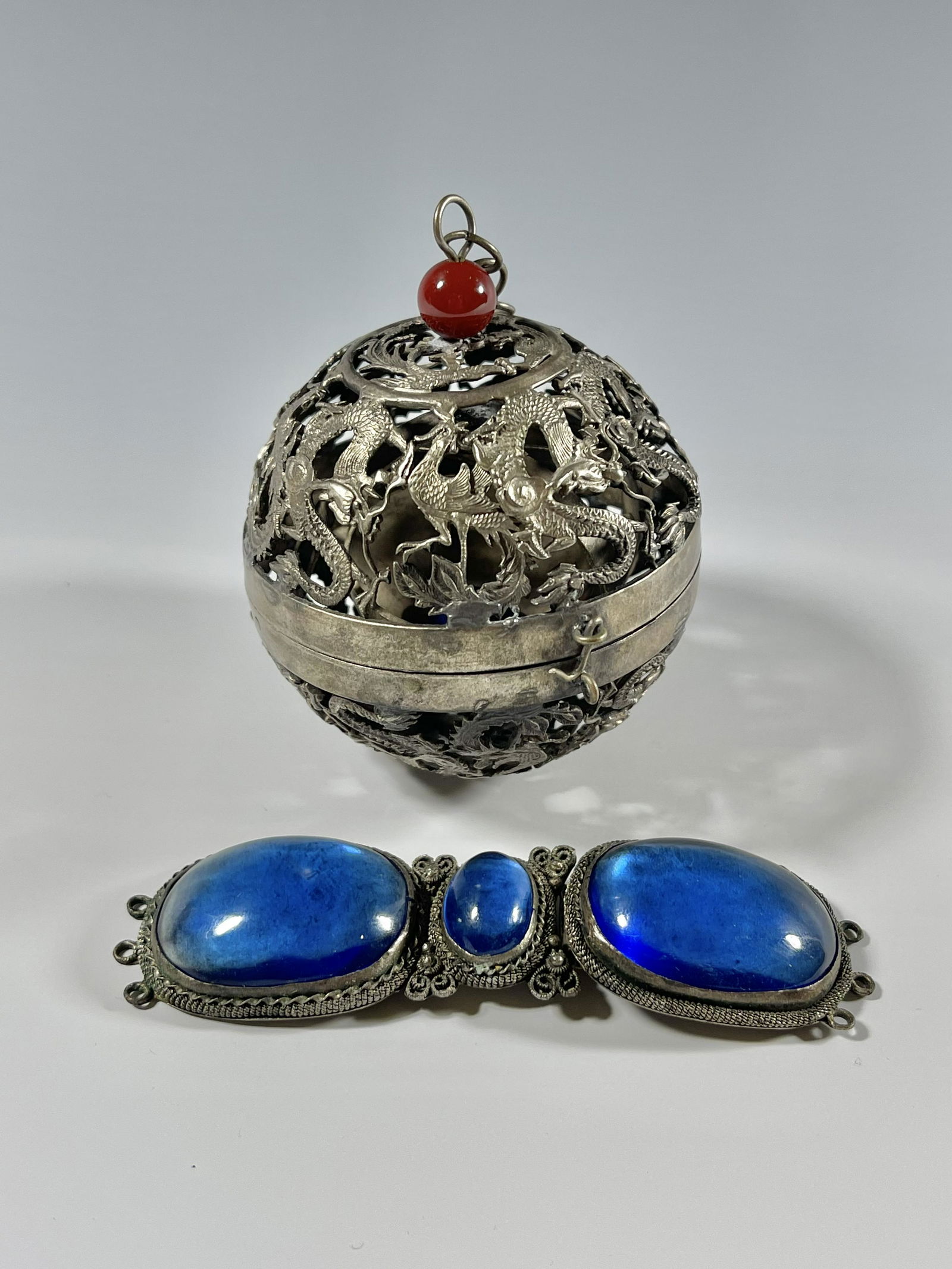 A SILVER SPHERICAL INCENSE BURNER AND A BELT BUCKLE (1 of 4)