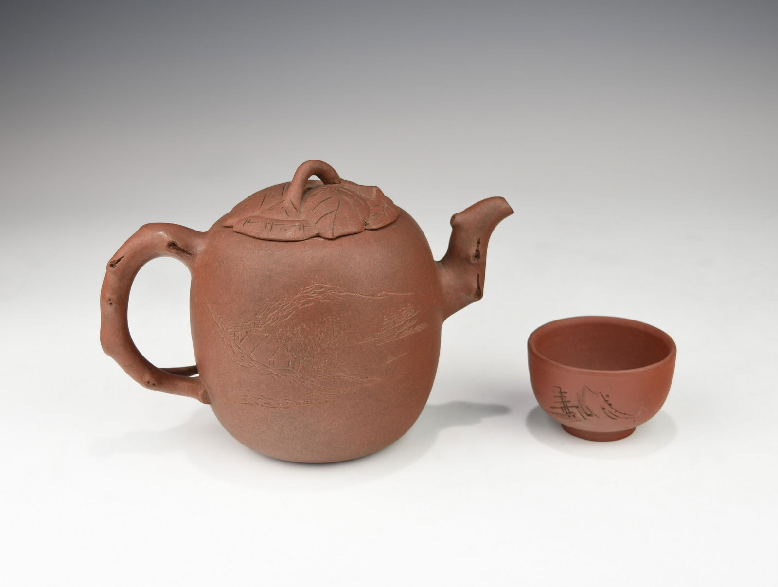 A CHINESE ZISHA TEAPOT AND A CUP (1 of 6)