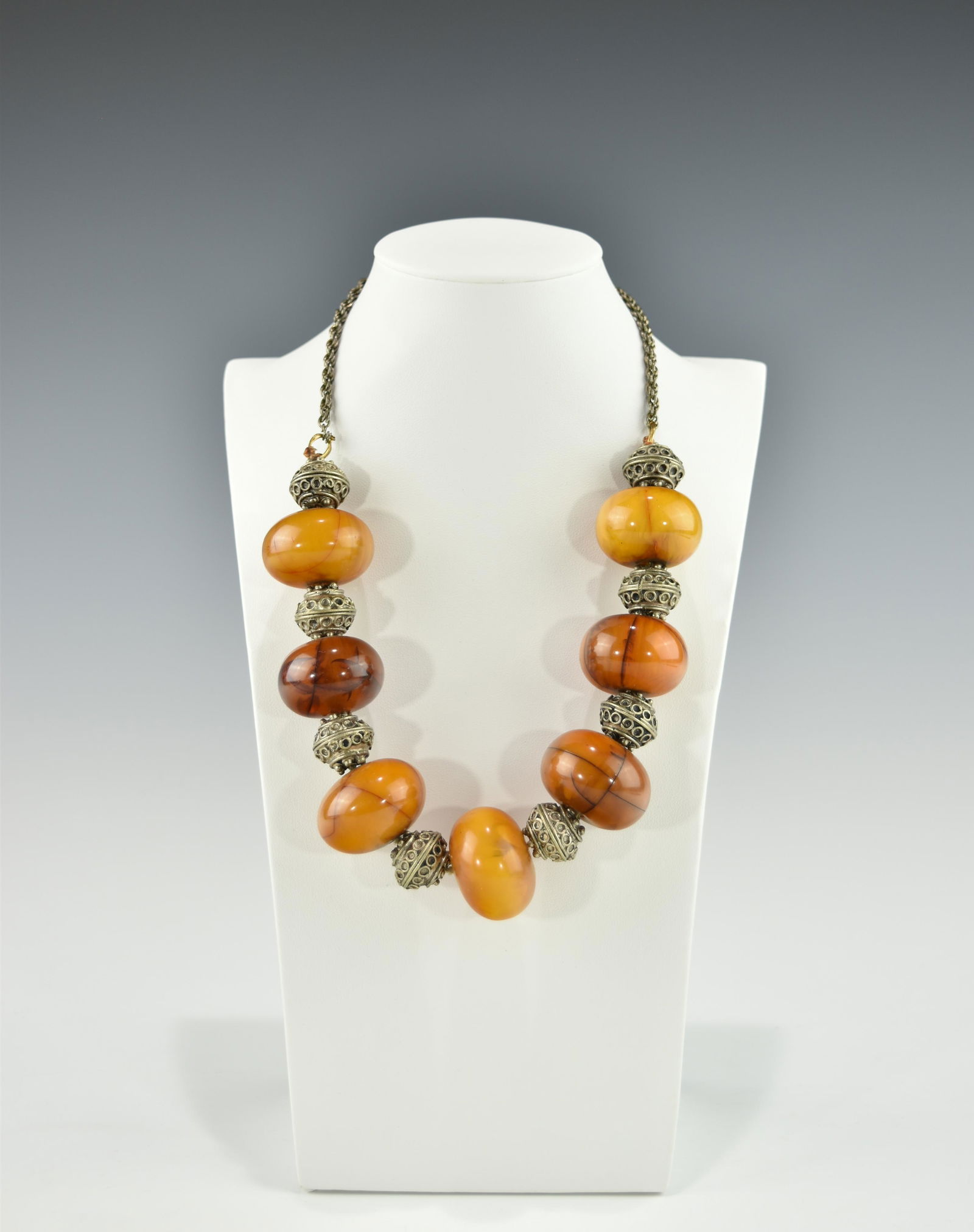 AN ANTIQUE TIBETAN AMBER AND SILVER BEAD NECKLACE: 19TH/20TH century, large amber beads, good condition. Necklace length 53 CM, 20 7/8 INCHES; Amber bead diameter 3.1 CM; Silver bead diameter 1.8 CM; Wt 180 gm