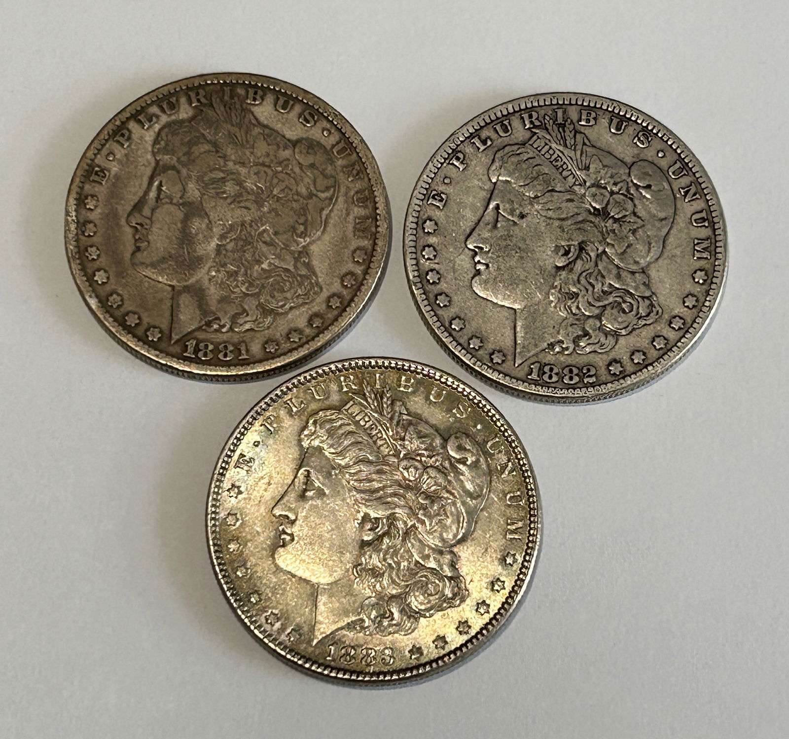A LOT OF THREE AMERICAN $1 MORGAN SILVER DOLLARS, CIRCA 1881, 1882 AND 1883 (1 of 4)