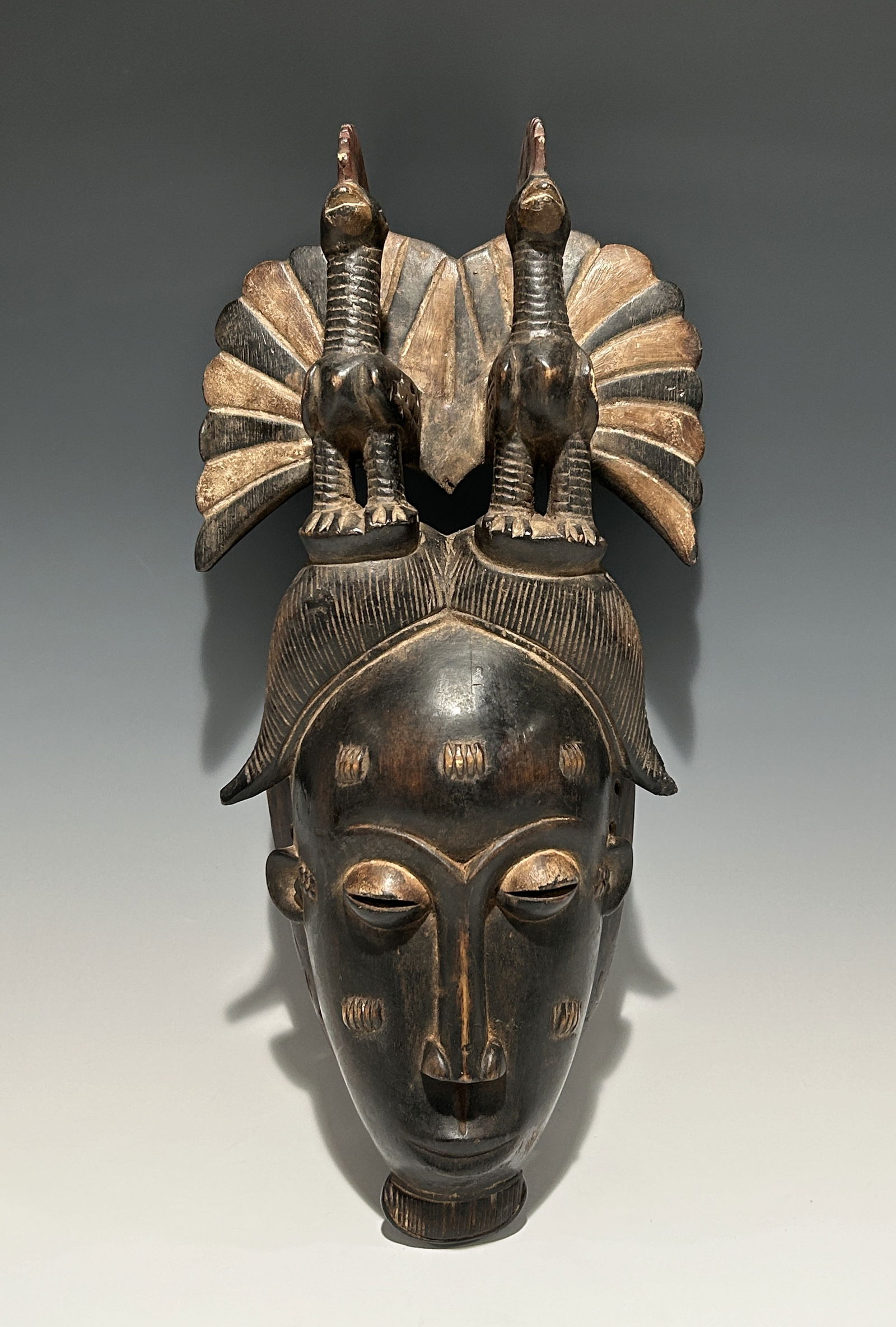 A TRADITIONAL AFRICAN IVORY COAST YOHOURE WOODEN KPELIE MASK WITH TWO PEACOCKS ATOP (1 of 8)